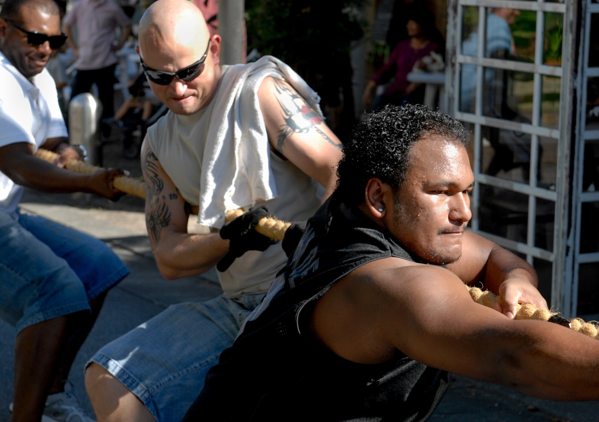 Airmen from Kadena Air Base, Air Force Sergeants Association and Airmen Committed to Excellence members compete in a tug-of-war competition at an event called Kanaderu Park at Chuo Park Avenue, Japan, June 30, 2012. Navy and Marine service members offered a variety of foods from chicken and rice to hot dogs to festival-goers to foster positive community relations. (U.S. Air Force photo/Airman 1st Class Malia Jenkins)