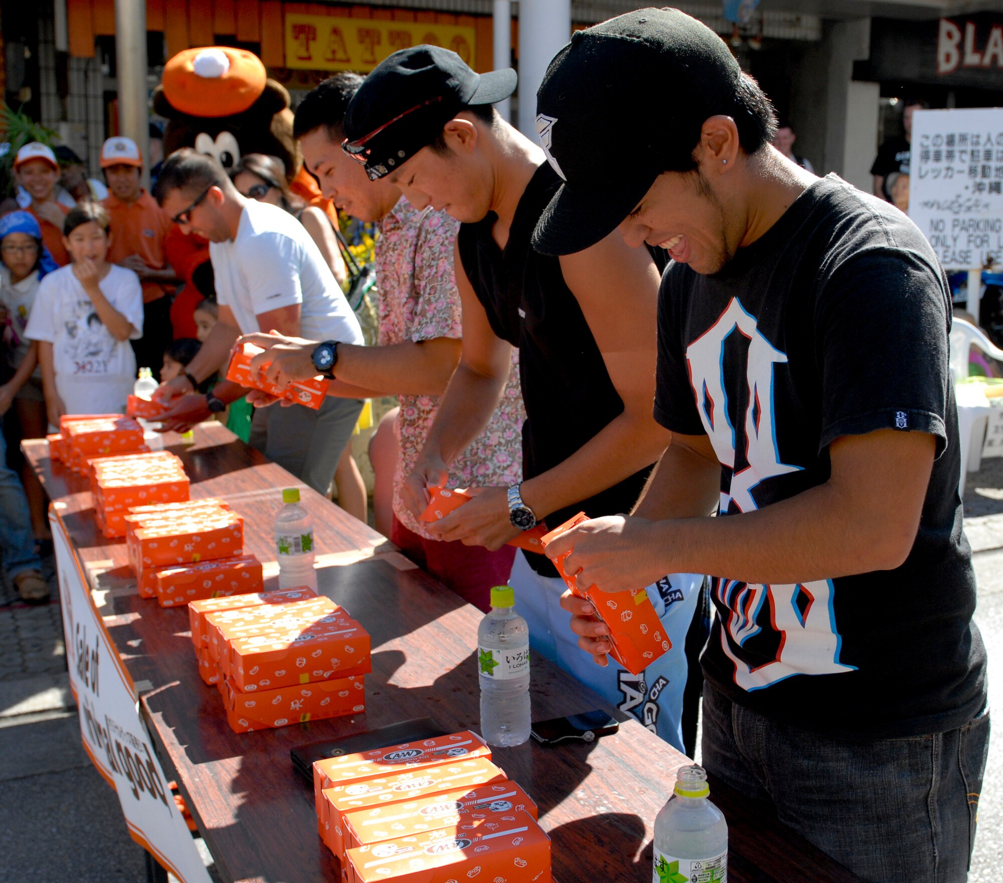 Airman 1st Class Julio Alvarado, 18th Operations Support Squadron intelligence analyst, joins a hot dog eating contest at an event called Kanaderu Park at Chuo Park Avenue, Japan, June 30, 2012. Kadena service members participated in the competition to foster positive community relations. (U.S. Air Force photo/Airman 1st Class Malia Jenkins)