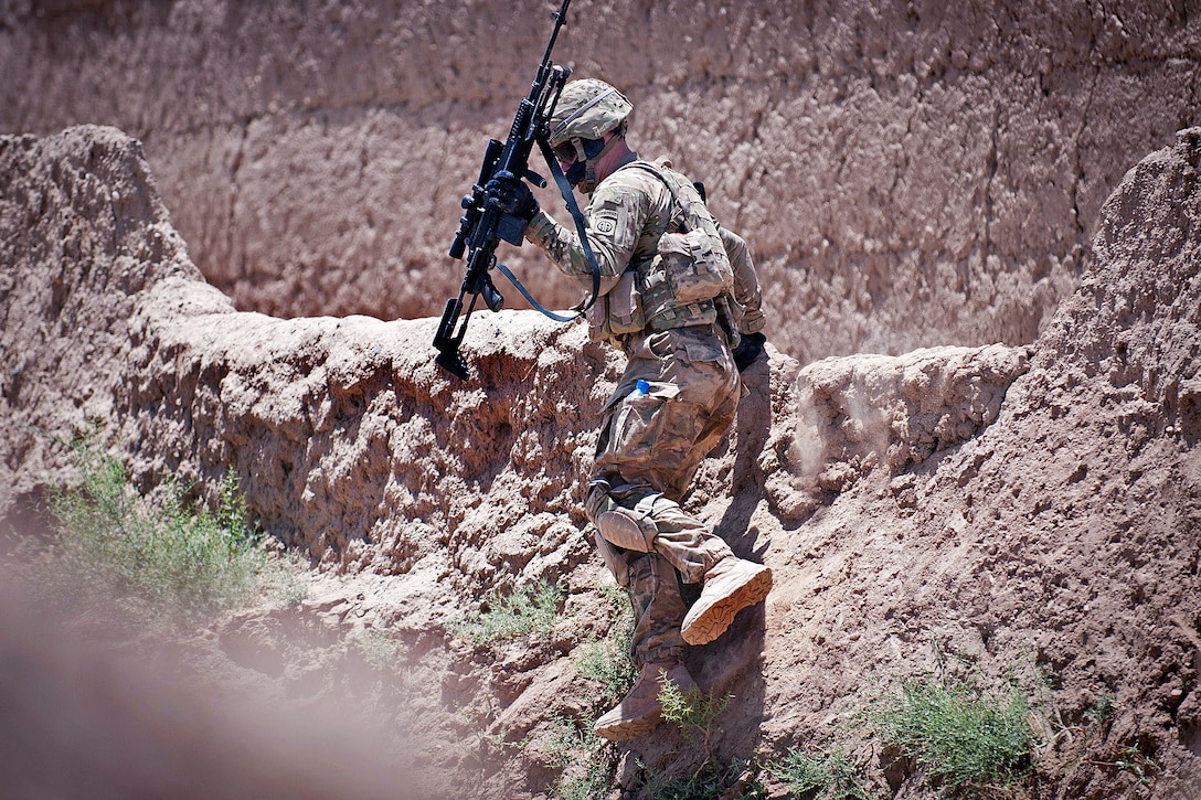 A U.S. paratrooper jumps over a kalat wall while returning from a partnered patrol near Muqor in Afghanistan's Ghazni province, June 25, 2012.