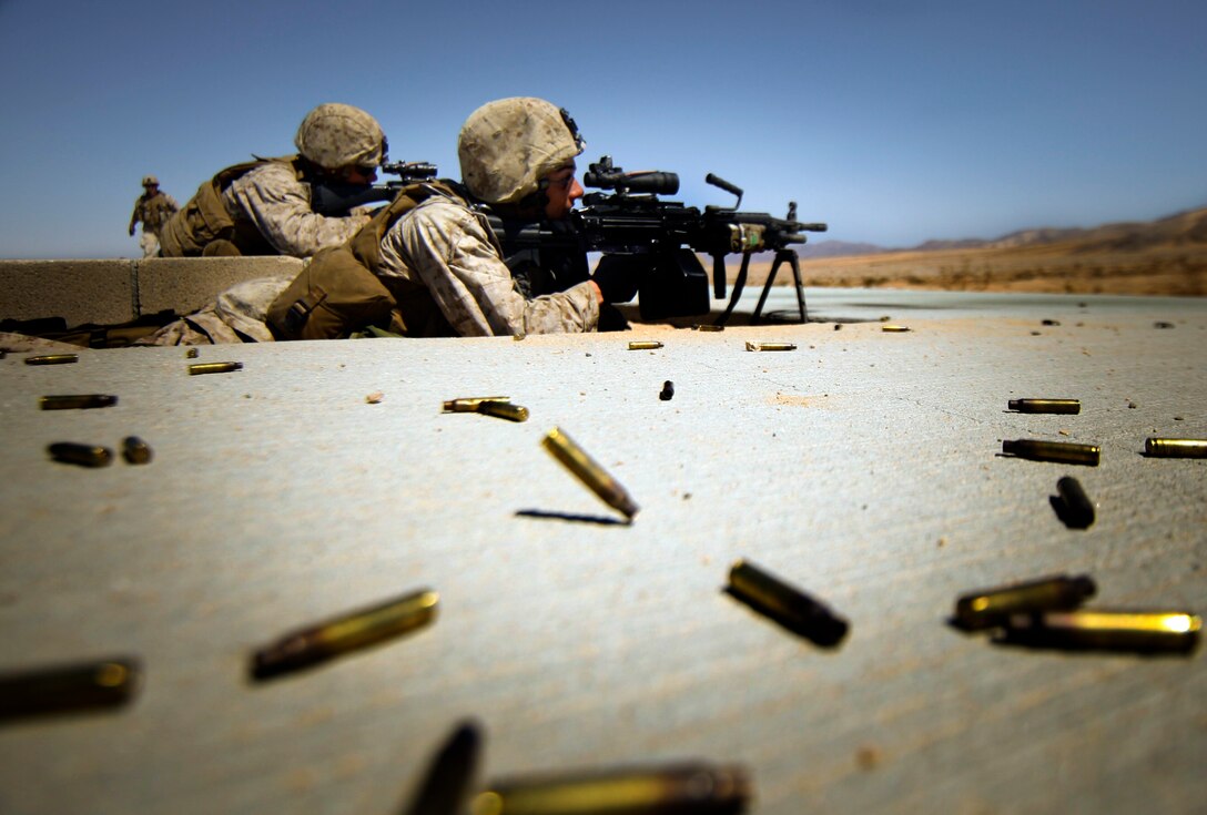 MARINE CORPS AIR GROUND COMBAT CENTER TWENTYNINE PALMS, Calif. - Marines with Company E, 2nd Battalion, 25th Marine Regiment, Marine Forces Reserve, send rounds down range with an M249 Squad Automatic Weapon and an M4 rifle during exercise Javelin Thrust 2012.  Javelin Thrust 2012 is an annual large scale exercise which allows active and reserve Marines and Sailors from 38 different states to train together as a seamless Marine Air Ground Task Force. (Photo by Sgt. Alvin D. Parson/Released)