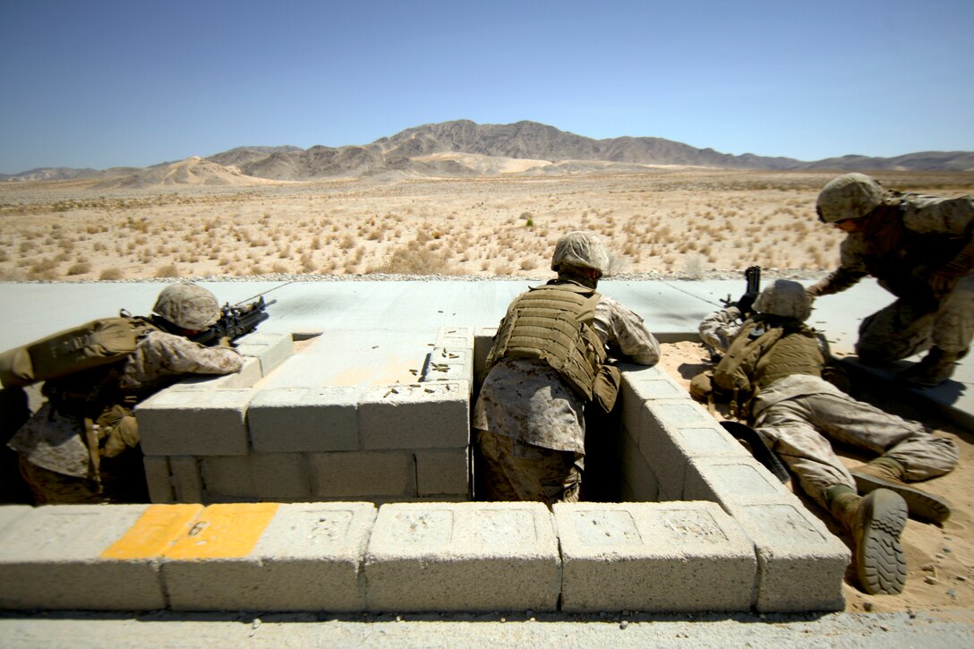 MARINE CORPS AIR GROUND COMBAT CENTER TWENTYNINE PALMS, Calif. - Marines with Company E, 2nd Battalion, 25th Marine Regiment, Marine Forces Reserve, send rounds down range with an M249 Squad Automatic Weapon and an M4 rifle during Exercise Javelin Thrust 2012.  Javelin Thrust 2012 is an annual large scale exercise which allows active and reserve Marines and Sailors from 38 different states to train together as a seamless Marine Air Ground Task Force. (Photo by Sgt. Alvin D. Parson/Released)