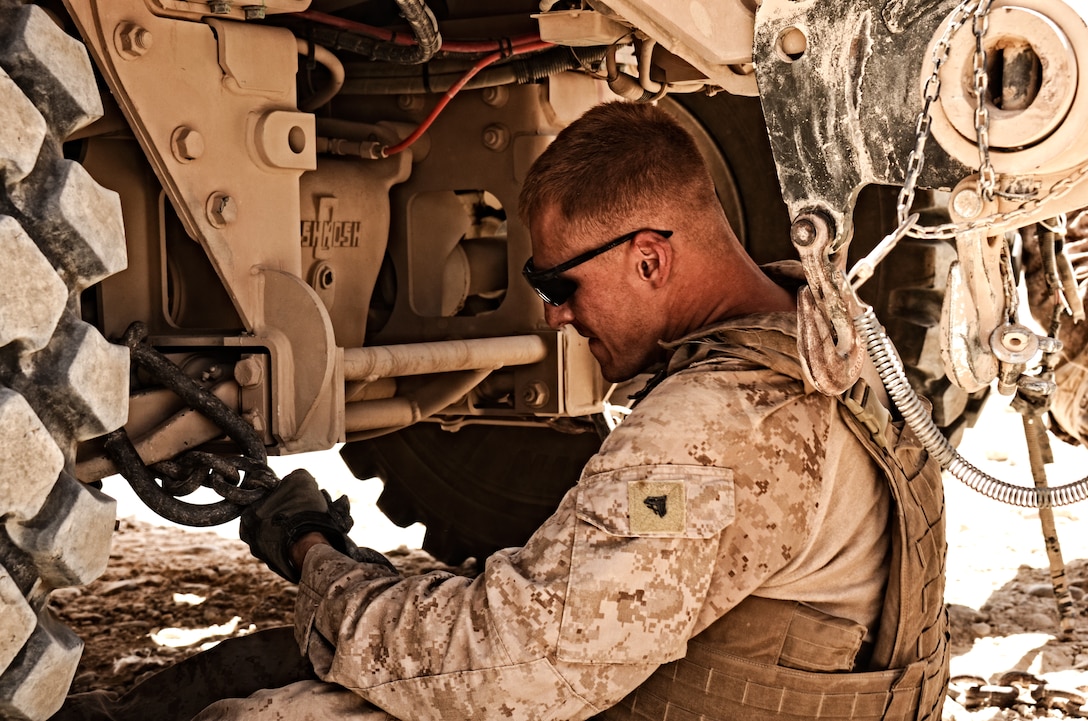 Cpl. Adam R. Tornatore, wrecker operator, Support Company, Combat Logistics Battalion 4, 1st Marine Logistics Group (Forward), rigs a mine resistant ambush protected vehicle for tow following a combat logistics patrol to Combat Outpost Shir Ghazay, July 3. Tornatore has established a reputation as one of the battalion’s duty experts on vehicle recoveries.