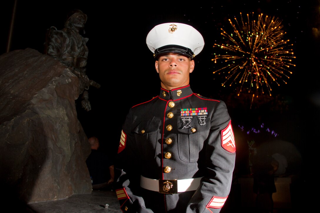 Sgt. Geovanni Cruz, 28, from New Britain, Conn., celebrates Independence Day at the Honoring All Veterans Memorial on July 4. Cruz is a motor transportation mechanic with Marine Wing Support Squadron 471. The memorial recognizes the first flag-raising on Iwo Jima. The centerpiece is a bronze bust of former Richfield, Minn., resident Cpl. Charles Lindberg.