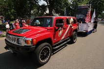 Recruiting Substation Coon Rapids' Sgt. Matt Talbot reaches the end of the Forest Lake Festival parade July 4. Talbot and several poolees distributed stickers and bookmarks along the parade route while pulling the Gold Star Family Weekend float. This is the second year in a row that Marines with Recruiting Station Twin Cities have participated in the parade.