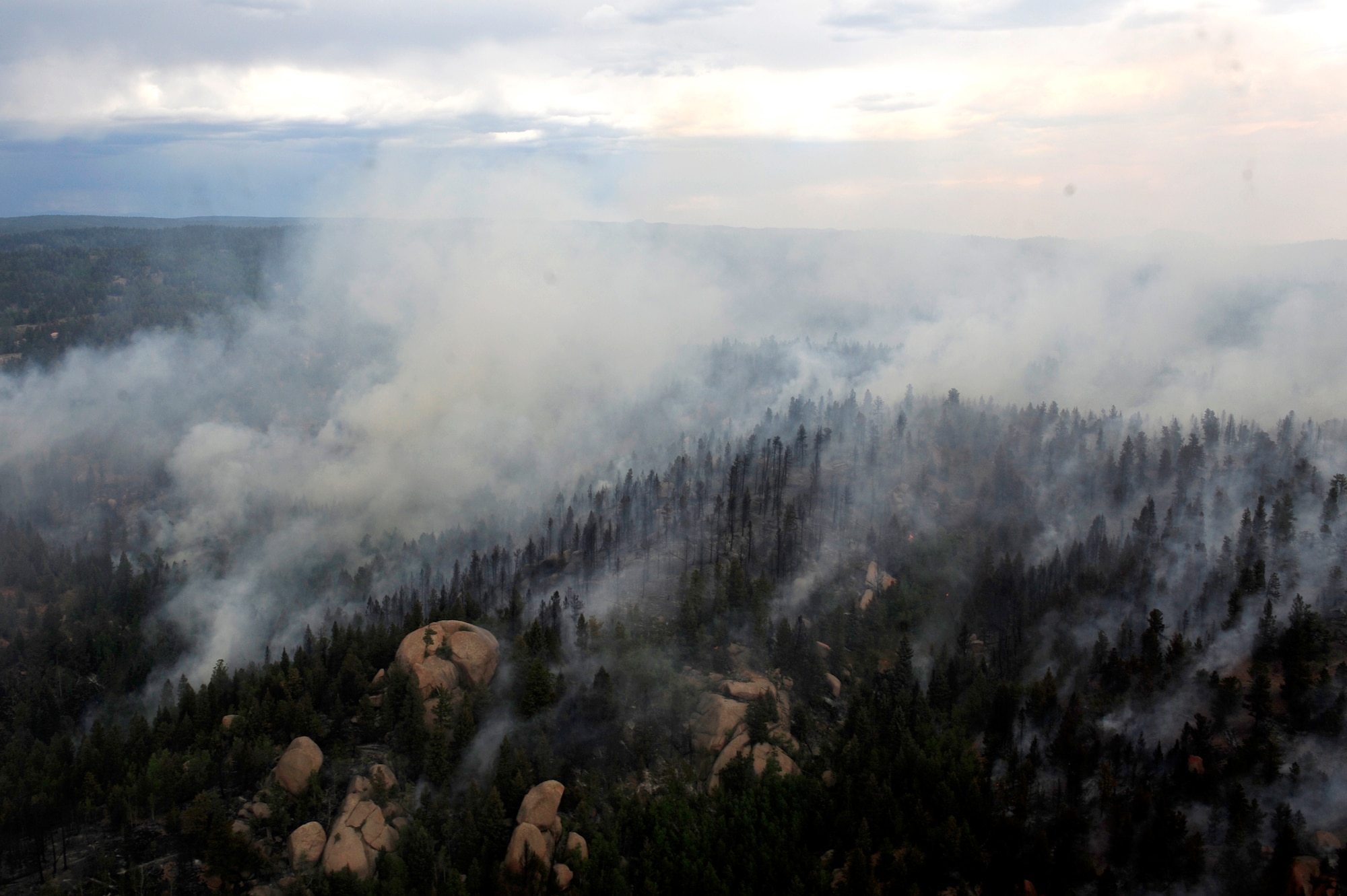 The Waldo Canyon Fire rages June 27 near Colorado Springs, Colo., as Air Force Reservists from the 302nd Airlift Wing fly overhead in a Modular Airborne Fire Fighting System-equipped C-130 Hercules aircraft. MAFFS is a self-contained aerial firefighting system that can discharge 3,000 gallons of water or fire retardant in less than five seconds, covering an area one-quarter of a mile long by 100 feet wide. The 302nd AW is based at Peterson Air Force Base, Colo. (U.S. Air Force photo/Staff Sgt. Stephany D. Richards)