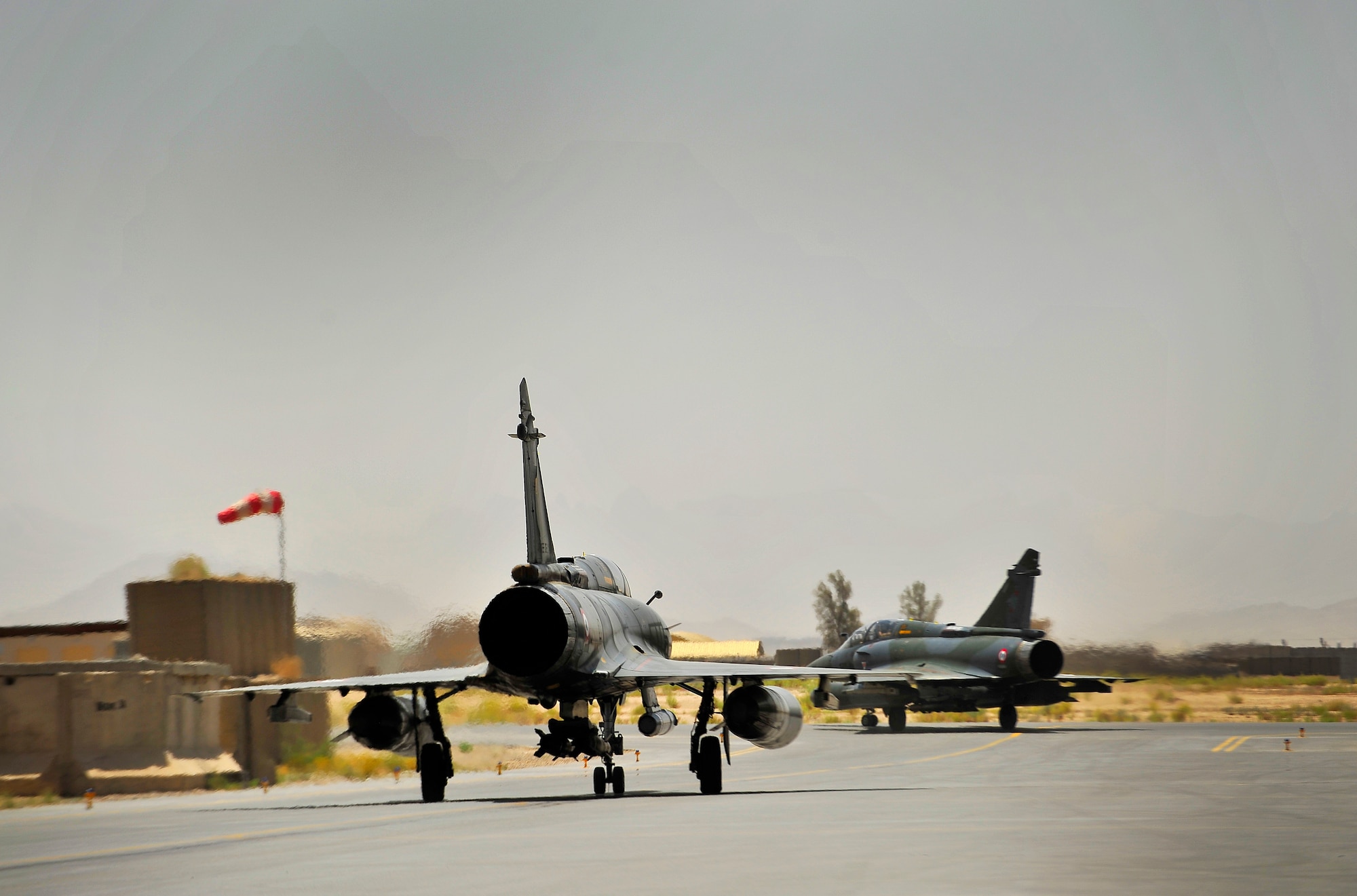 Members of the French Air Force, Detachment 3/3, taxi towards a takeoff point in the French's Mirage 2000-D before a combat mission at Kandahar Airfield, Afghanistan, June 15, 2012. The French AF has been a coalition partner with the U.S. during Operation Enduring Freedom (OEF) and perform air to ground close air support missions for friendly ground forces. (U.S. Air Force photo/Staff Sgt. Clay Lancaster)
