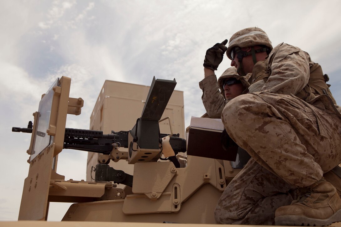 Cpl. Adam Waldron, an armorer with Bulk Fuel Co. A, 6th Engineer Support Bn. and native of Phoenix, Ariz., instructs Lance Cpl. Patrick Hayes, of Yuma, Ariz., on the finer points of M240G machine gunnery during Exercise Javelin Thrust. Javelin Thrust is an annual large-scale exercise here which allows active and reserve Marines and sailors from 38 different states to train together as a seamless Marine Air Ground Task Force.