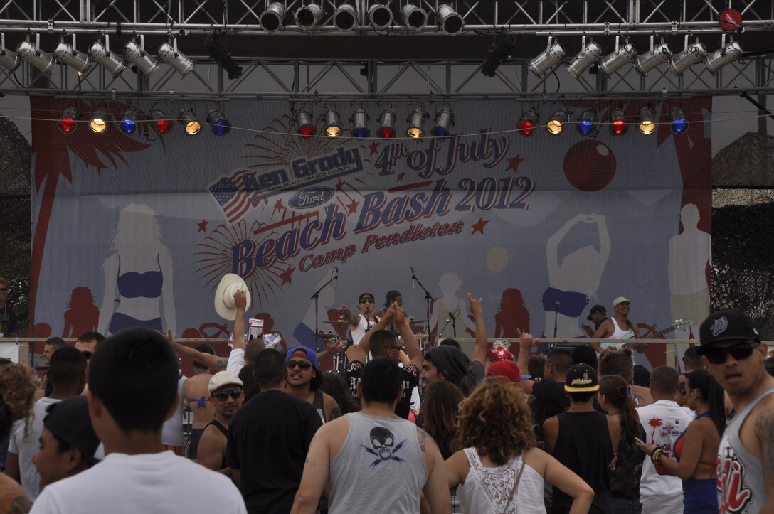 Camp Pendleton Marines, families and sailors enjoy a performance from a local cover band at Camp Pendleton's Del Mar Beach during the 4th of July Beach Bash. The Beach Bash has been around for 28 years, giving Marines, families and sailors a chance to enjoy their nation's birthday and the freedoms they support and protect.