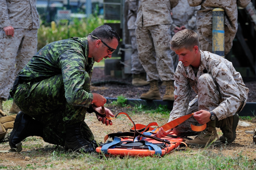 Corporal William Ripley, Medical Technician for 1 Field Ambulance in Edmonton, Alberta, and Hospital Corpsman Stephen Lattin from 1st Battalion, 3rd Marine Regiment, prepare a stretcher at Marine Corps Base Hawaii, July 2. Twenty-two nations, more than 40 ships and submarines, and more than 200 aircraft and 25,000 personnel are participating in the biennial Rim of the Pacific (RIMPAC) exercise from June 29 to Aug. 3, in and around the Hawaiian Islands. The world's largest international maritime exercise, RIMPAC provides a unique training opportunity that helps participants foster and sustain the cooperative relationships that are critical to ensuring the safety of sea lanes and security on the world's oceans. RIMPAC 2012 is the 23rd exercise in the series that began in 1971.