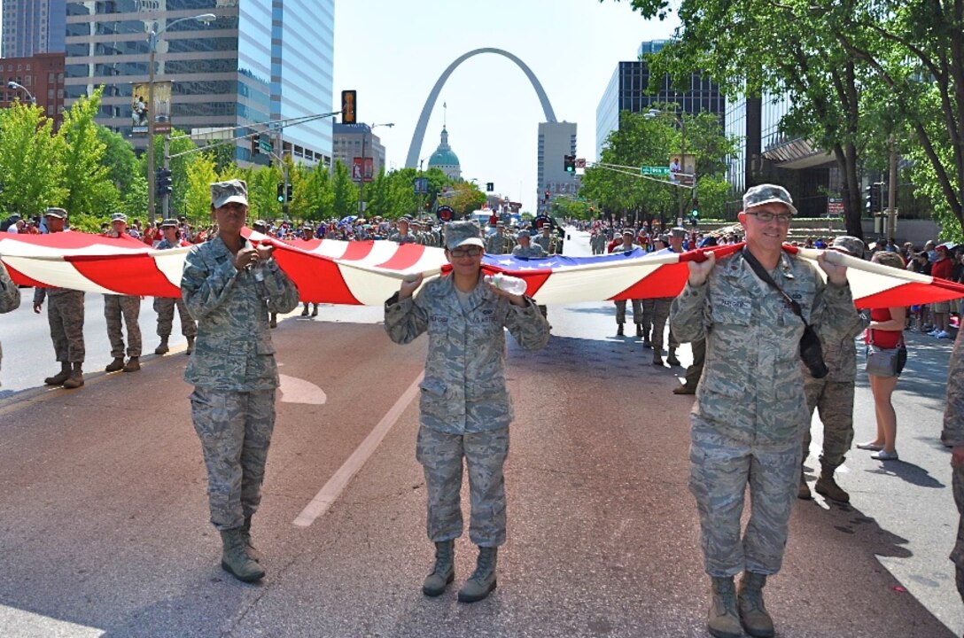 Some 25 reservists from the 932nd Airlift Wing pause briefly during the 135th annual Veiled Prophet Fair Parade in downtown St. Louis. The reservists marched a huge U.S. flag  in the parade and thousands of cheering specators ignored the 103 degree heat and enjoyed one of the largest Independence Day parades held in the U.S. The 932nd AW, is known as the Gateway Wing, for its close proximity to the Gateway Arch. The reserve wing is located at Scott Air Force Base, Ill., and flies the C-40C airplane. (U.S. Air Force photo/Tech. Sgt. Dan Oliver) 

