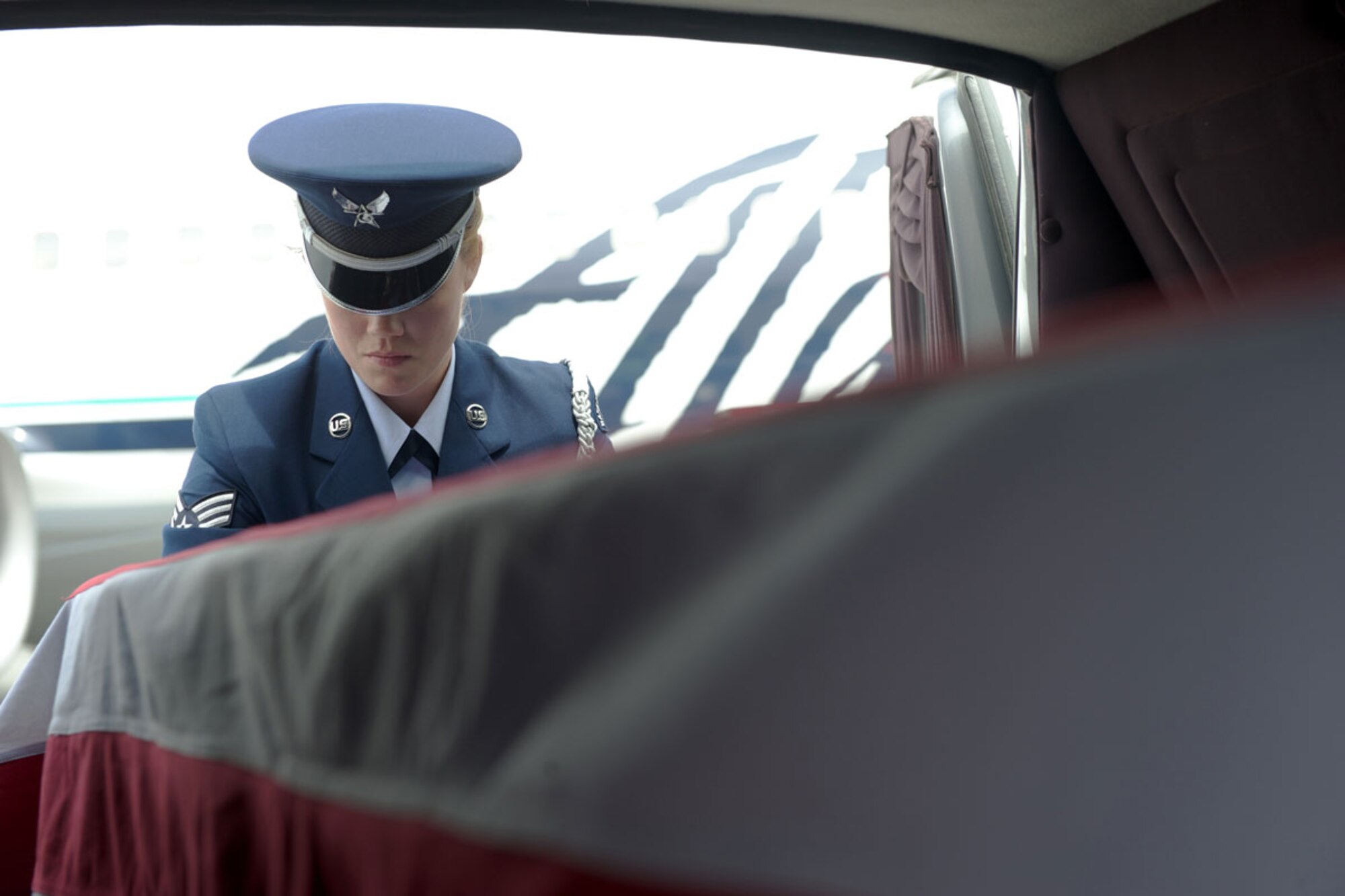 Senior Airman Brittney Flores prepares to unload a transfer case at the Ted Stevens Anchorage International Airport June 28. The case contained material evidence and possible human remains from a C-124 Globemaster II crash which occurred Nov. 22, 1952, killing all 52 personnel on board. The wreckage partially surfaced on Colony Glacier and was spotted June 10. The transfer case was fl own to Joint POW/MIA Accounting Command on Joint Base Pearl Harbor-Hickam, Hawaii, so the contents could be analyzed. (U.S. Air Force photo/Staff Sgt. Robert Barnett)
