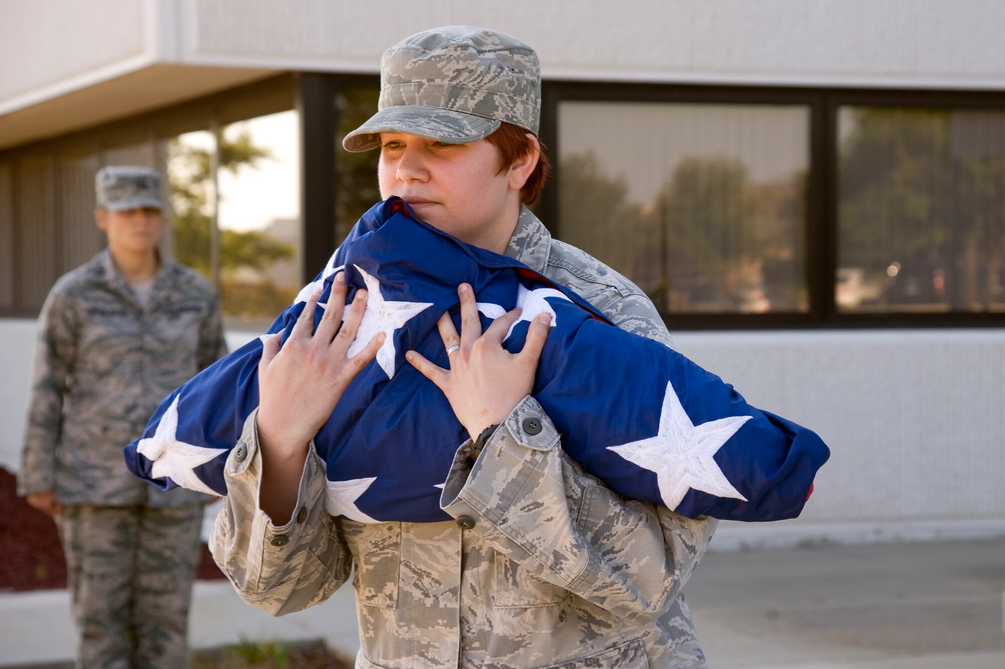 Staff Sgt. Megan Knight, an aviation management technician from 1st Special Operations Support Squadron, secures the American flag after it is folded during the weekly retreat ceremony in front of 1st Special Operations Wing headquarters at Hurlburt Field, Fla., June 27, 2012. The flag detail members from the squadrons are trained in how to perform retreat ceremonies by the base honor guard. (U.S. Air Force photo/Airman 1st Class Michelle Vickers)  (Released)

