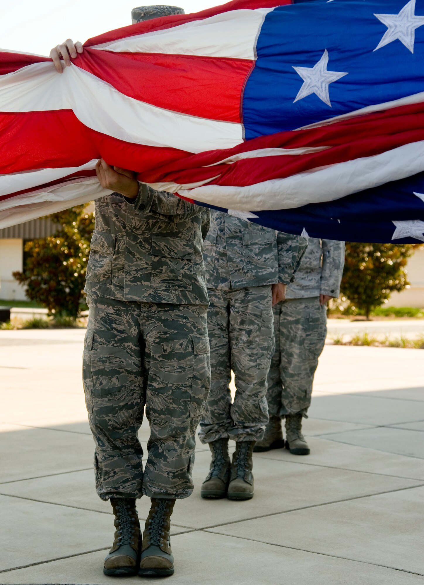 A line of Airmen from the 1st Speciial Operations Support Squadron perform flag detail during a retreat cermony in front of 1st Special Operations Wing headquarters at Hurlburt Field, Fla., June 27, 2012. The honor of performing retreat is rotated among different squadrons on base. (U.S. Air Force photo/Airman 1st Class Michelle Vickers)  (Released)

