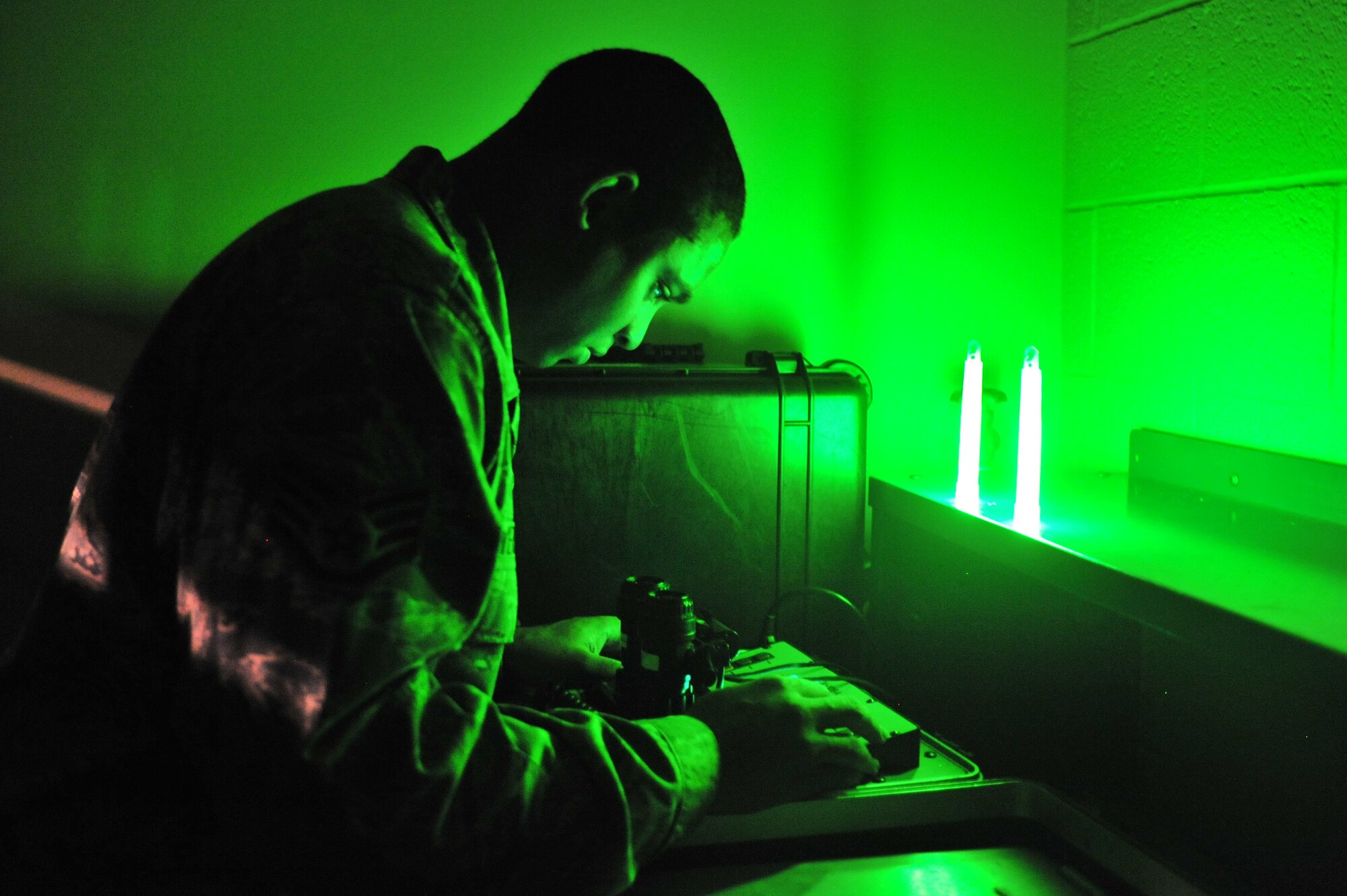 U.S. Air Force Staff Sgt. David Showers, 27th Special Operations Support Squadron aircrew flight equipment specialist, examines night vision gear at Cannon Air Force Base, N.M., July 3, 2012. Aircrew flight equipment specialists inspect, maintain and adjust life support and survival gear for flight crew members assigned to Cannon. (U.S. Air Force photo by Airman 1st Class Eboni Reece)