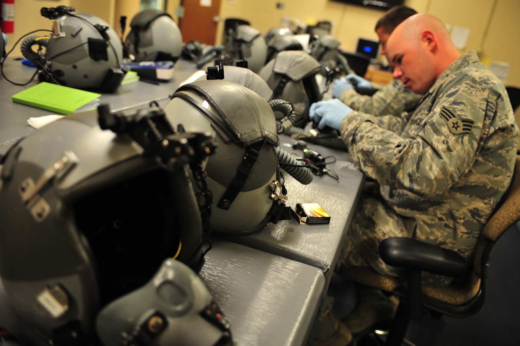 U.S. Air Force Senior Airman Nicholas Byars and Airman 1st Class Robert McClung, 27th Special Operations Support Squadron aircrew flight equipment specialists, inspect and adjust components on helmets and oxygen masks at Cannon Air Force Base, N.M., July 3, 2012. Aircrew flight equipment specialists inspect, maintain and adjust life support and survival gear for flight crew members assigned to Cannon. (U.S. Air Force photo by Airman 1st Class Eboni Reece)
