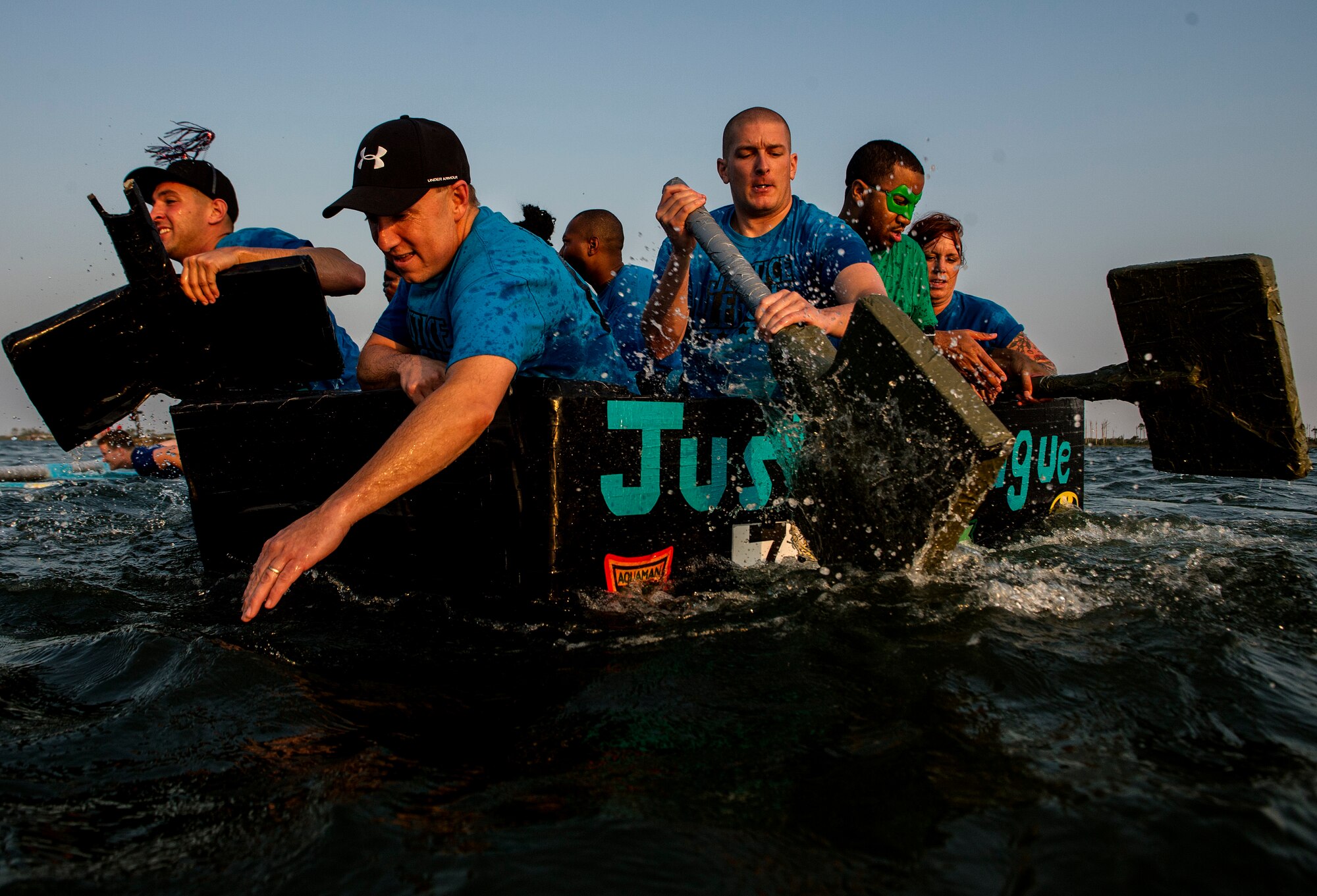 U.S. Air Force airmen from the 1st Special Operations Wing Judge Advocate row during the final stretch of the 24th Annual Cardboard Boat Regatta at the marina on Hurlburt Field, Fla., June 29, 2012. The 1st Special Operations Equipment Maintenance Squadron defended their title another year and won. (U.S. Air Force photo / Airman 1st Class Christopher Williams) (RELEASED)