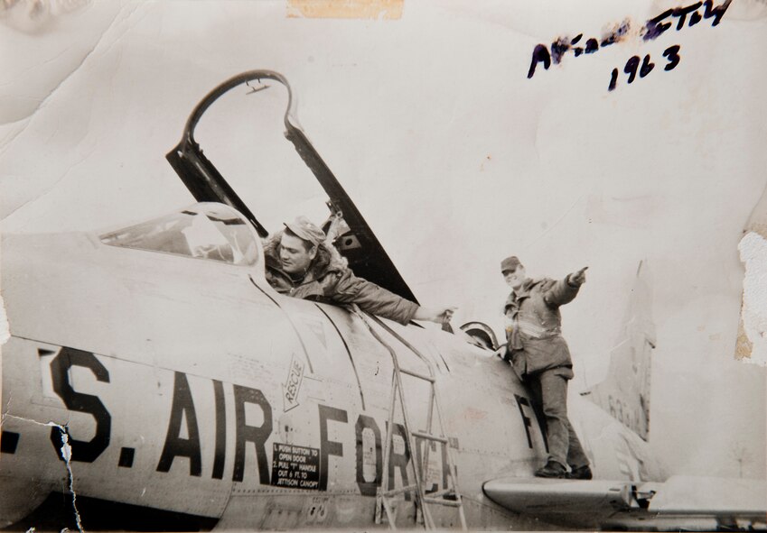 U.S. Air Force retired Master Sgt. Carl Hackworth does a flight control check on an F-100 Super Sabre with fellow Airman Richard Evinasky at Aviano Air Base, Italy, 1963. Hackworth worked on many aircraft including the F-100 throughout his Air Force career as a crew chief before retiring in Valdosta, Ga., Aug. 1, 1977. (Courtesy photo)