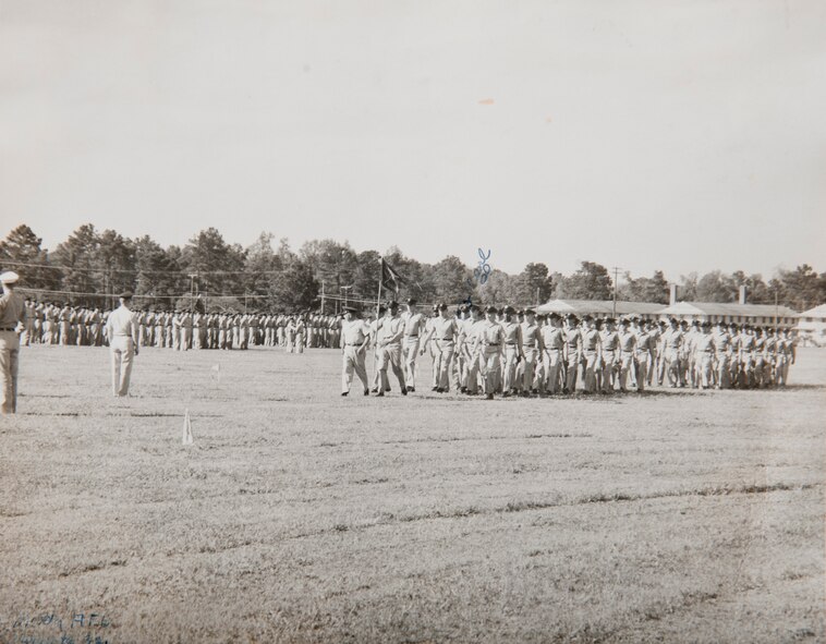 Airmen form up on an early Saturday morning in 1957 to celebrate a pilot’s entrance into Pilot Navigator School, which is now where the 23d Medical Group resides at Moody Air Force Base, Ga. Barracks where first-term Airmen lived are visible in the photo background. (Courtesy photo)