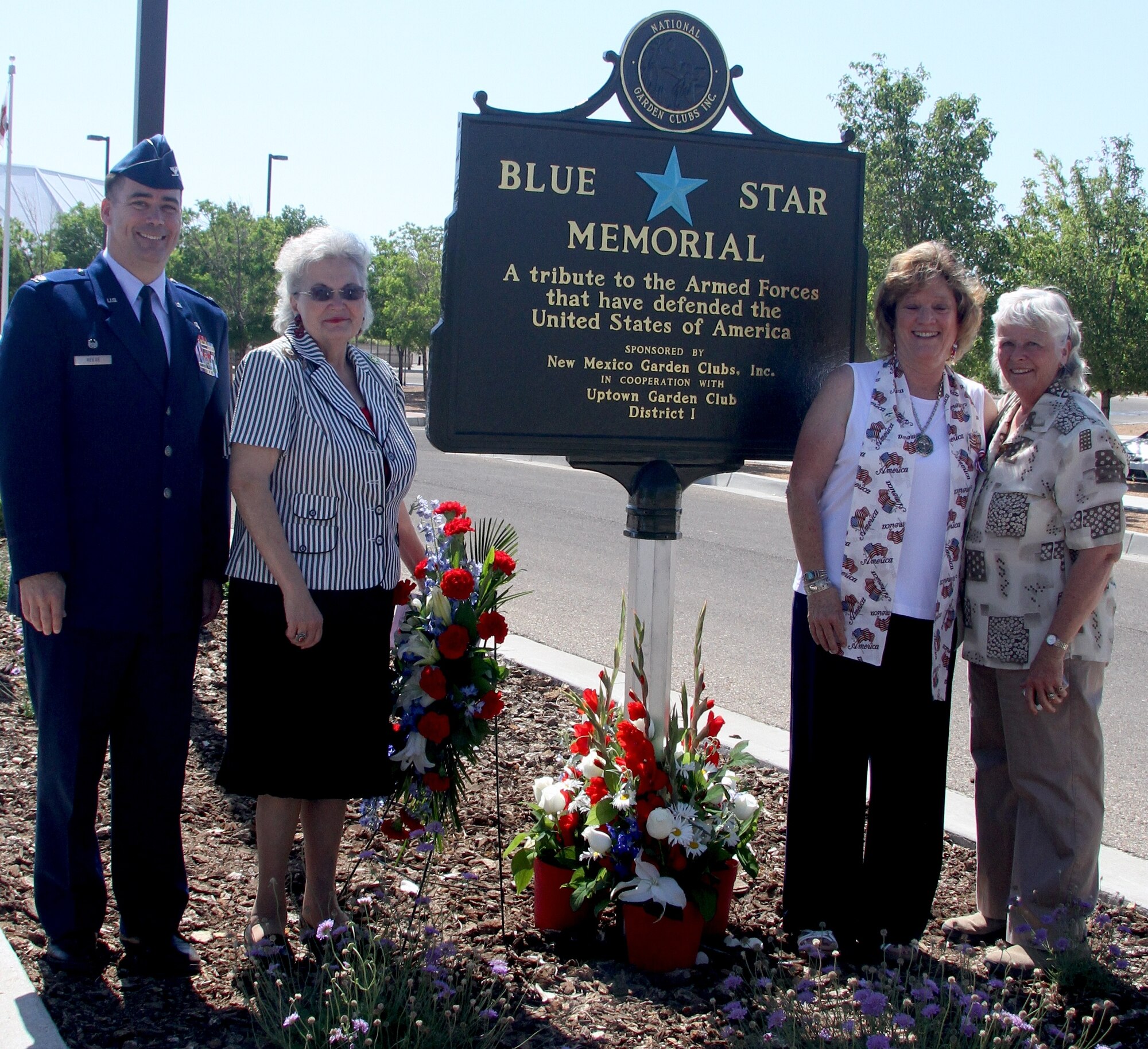 KIRTLAND AFB, N.M. -- From left, Col. Steve Reese, 377th Medical Group commander, Judy Grotts, National Garden Clubs, Inc., South Central Region director, Shirley Tetreault, President of New Mexico Garden Clubs, Inc., and Colleen Hinker, immediate past president of New Mexico Garden Clubs, unveil a new Blue Star Memorial on June 23 at the New Mexico Veterans Memorial in Albuquerque, N.M. (Courtesy photo)