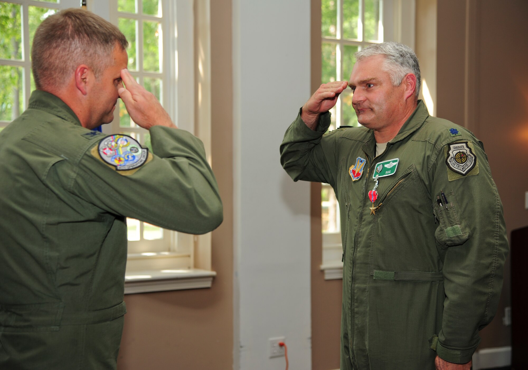 U.S. Air Force Lt. Col. David Moeller, 335th Fighter Squadron commander, salutes Col. Michael Koscheski, 4th Operations Group commander, after receiving a Bronze Star Medal on Seymour Johnson Air Force Base, N.C., June 29, 2012. Moeller led Air Force Central Command’s largest F-15E Strike Eagle deployment since 2003. (U.S. Air Force photo/Tech. Sgt. Colette Graham/Released)