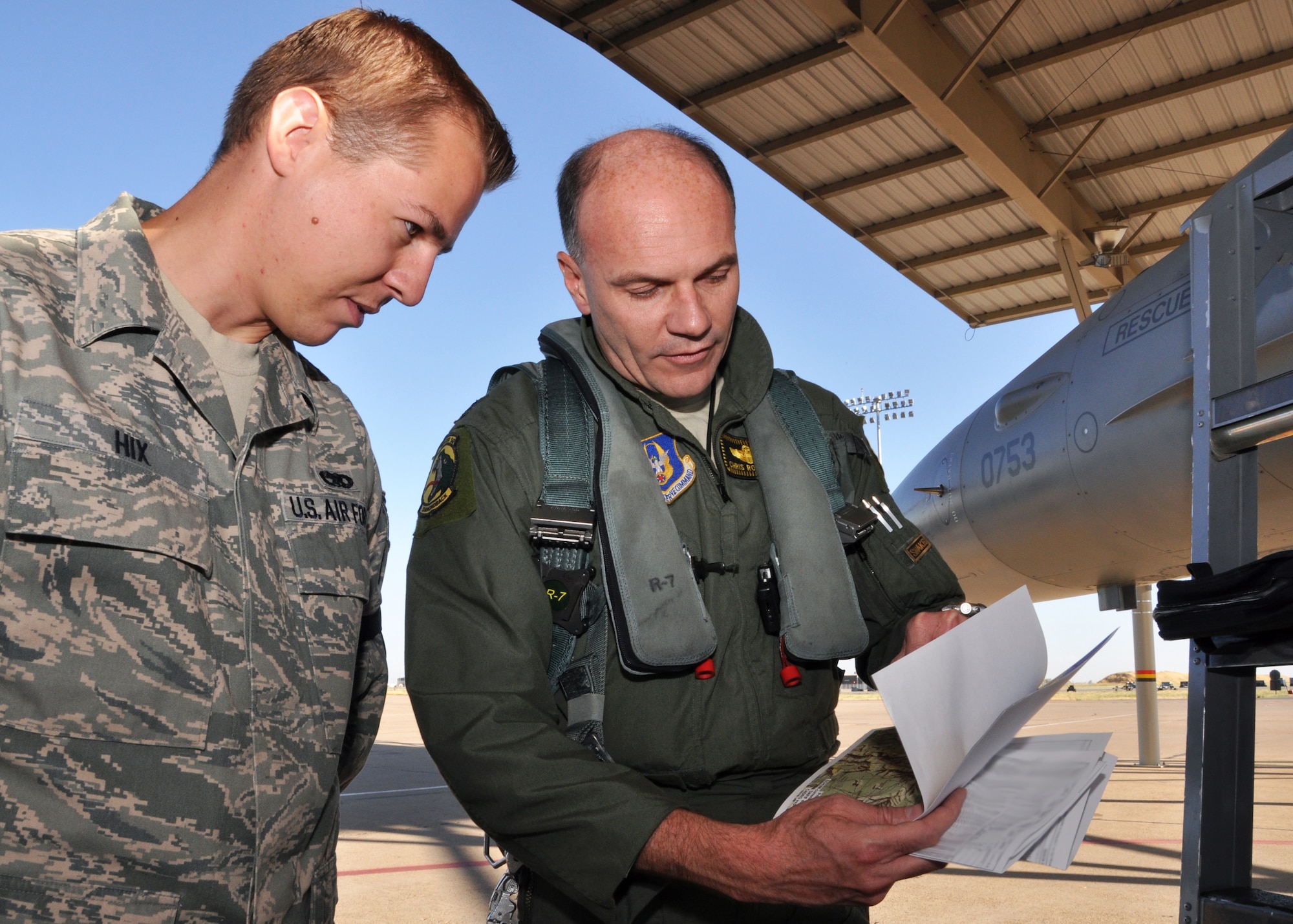 Lt. Col. Chris Robinson, 466th Fighter Squadron, explains his flyover route to Staff Sgt. Matthew Hix, 419th Aircraft Maintenance Squadron crew chief. Robinson and three other pilots flew over 19 cities, a distance of 700 miles. (U.S. Air Force photo/Crystal Charriere)