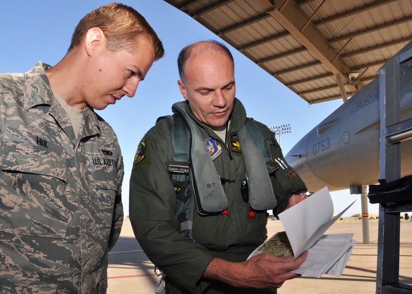 Lt. Col. Chris Robinson, 466th Fighter Squadron, explains his flyover route to Staff Sgt. Matthew Hix, 419th Aircraft Maintenance Squadron crew chief. Robinson and three other pilots flew over 19 cities, a distance of 700 miles. (U.S. Air Force photo/Crystal Charriere)