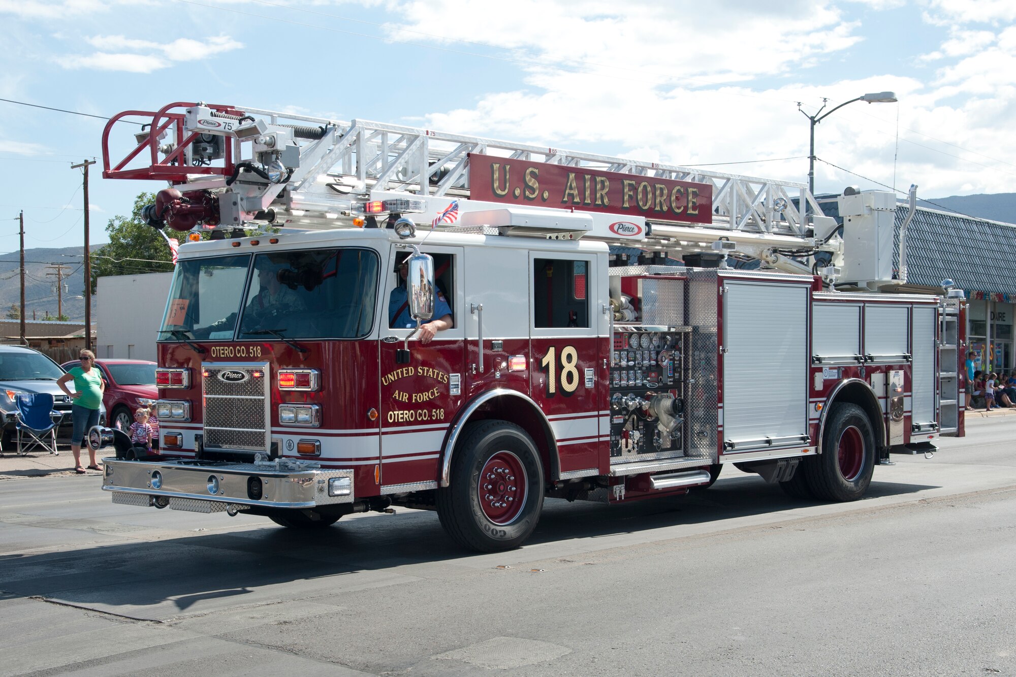 Firefighters with the Holloman Air Force Base 49th Civil Engineer Squadron drive a fire engine down 10th Street in the Alamogordo, N.M., Independence Day parade, July 4. The parade included participants from the Otero County and Holloman Air Force Base communities, and was in celebration of the adoption of the Declaration of Independence, which declared the U.S. an independent nation from Great Britain in 1776. (U.S. Air Force photo by Airman 1st Class Anthony M. Ward/Released)