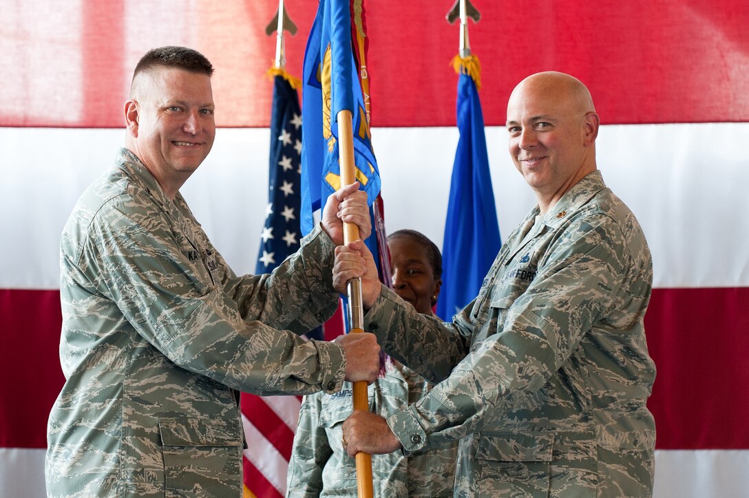 Maj. John Arellanes (right) accepts command of the 28th Maintenance Squadron from Col. James Katrenak, 28th Maintenance Group commander, during a change of command ceremony on Ellsworth Air Force Base, S.D, June 29, 2012. Arellanes, the former 28th Maintenance Operations Squadron commander, now commands more than 460 Airmen providing support for all maintenance equipment and heavy repairs, supporting 28 combat-coded B-1 aircraft and related subsystems. (U.S. Air Force photo by Airman 1st Class Kate Thornton/Released)