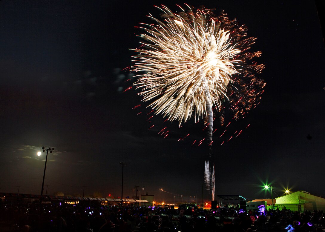 Under the cover of moonlight, families and friends from the base community filled Wings and Roberts Field to see the fireworks show, which was accompanied by patriotic music, during the 2012 Summer Bash at Edwards Air Force Base, Calif., on July 4. (U.S. Air Force photo by Jet Fabara)