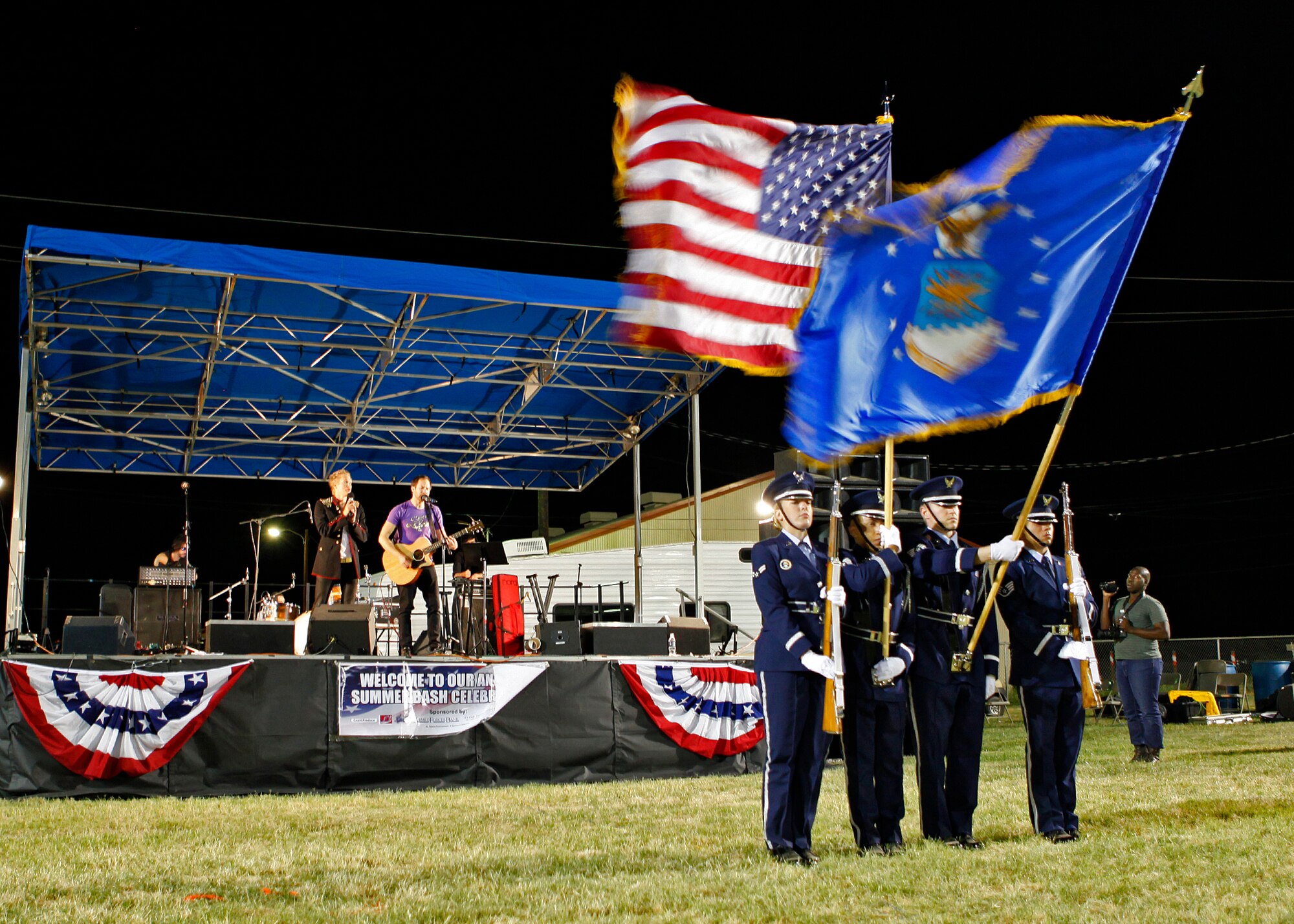The Blue Eagles Honor Guard present the colors prior to the fireworks demonstration during the 2012 Summer Bash on July 4 at Wings and Roberts Field. (U.S. Air Force photo by Jet Fabara)