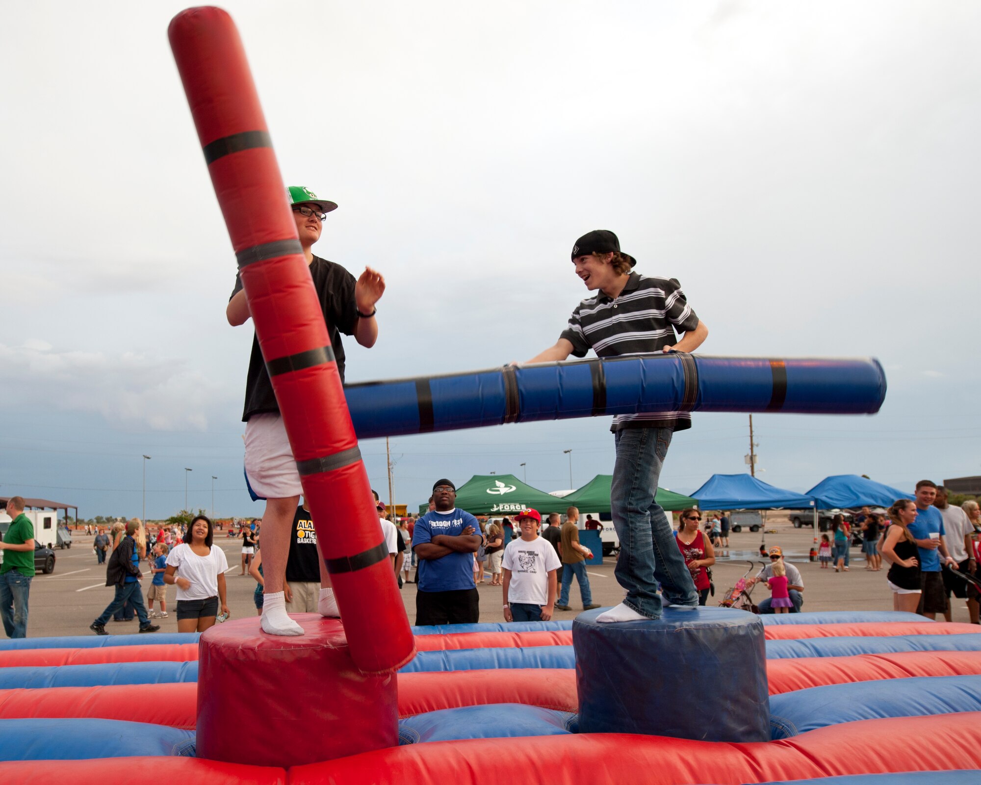 Two children battle with inflatable pugil sticks during the Freedom Fest Independence Day celebration at Holloman Air Force Base N.M., July 3. At the Freedom Fest, Team Holloman members enjoyed carnival games, rides, live music, and a fireworks display (U.S. Air Force photo by Airman Leah Ferrante/Released)