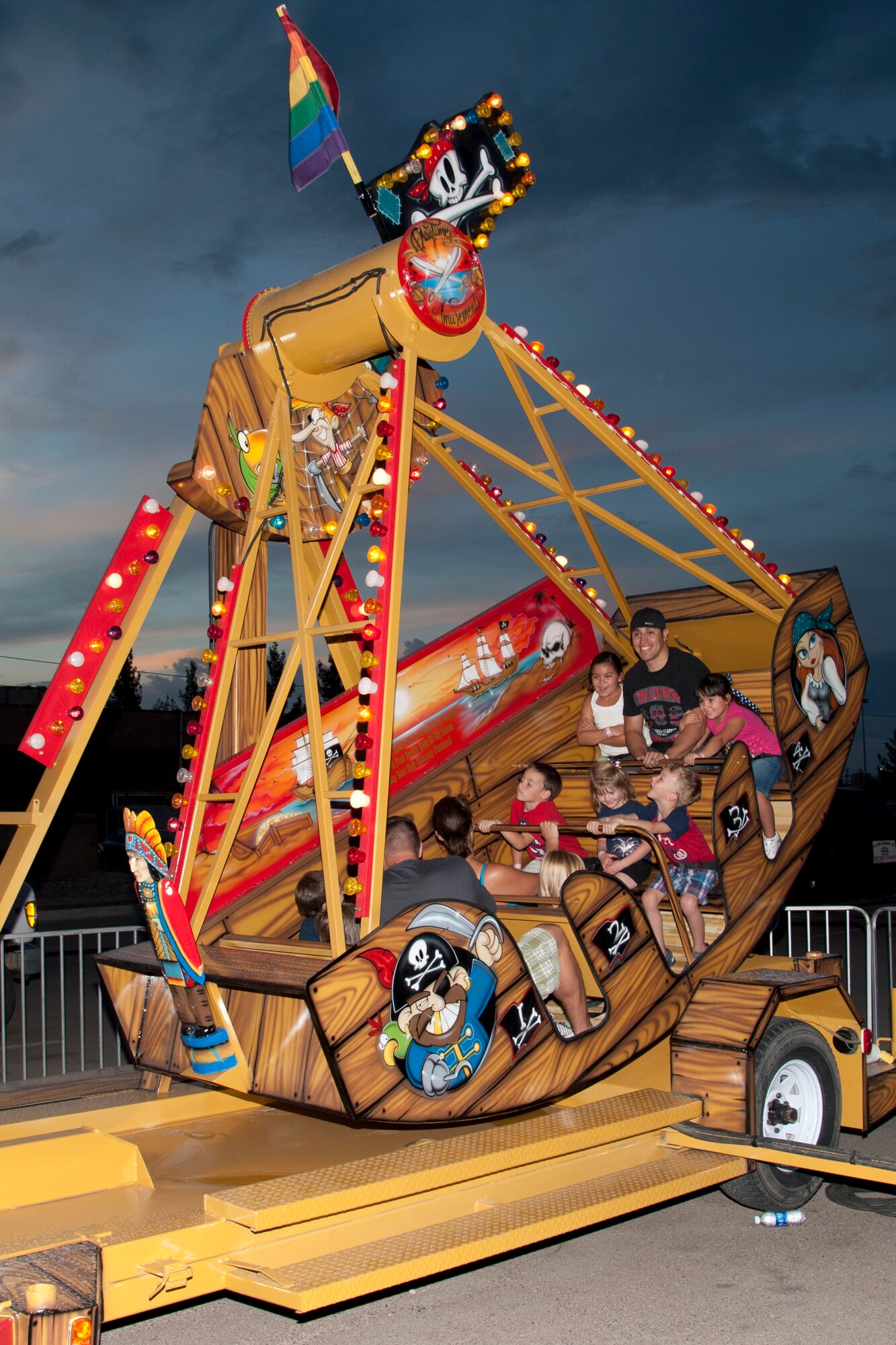 Members of Team Holloman enjoy one of the carnival rides available at the Freedom Fest Independence Day celebration at Holloman Air Force Base, N.M., July 3. Freedom Fest took place in the Domenici Fitness and Sports Center parking lot and included carnival games, live music, and a fireworks display for Airmen and their families. (U.S. Air Force photo by Airman 1st Class Anthony M. Ward/Released)