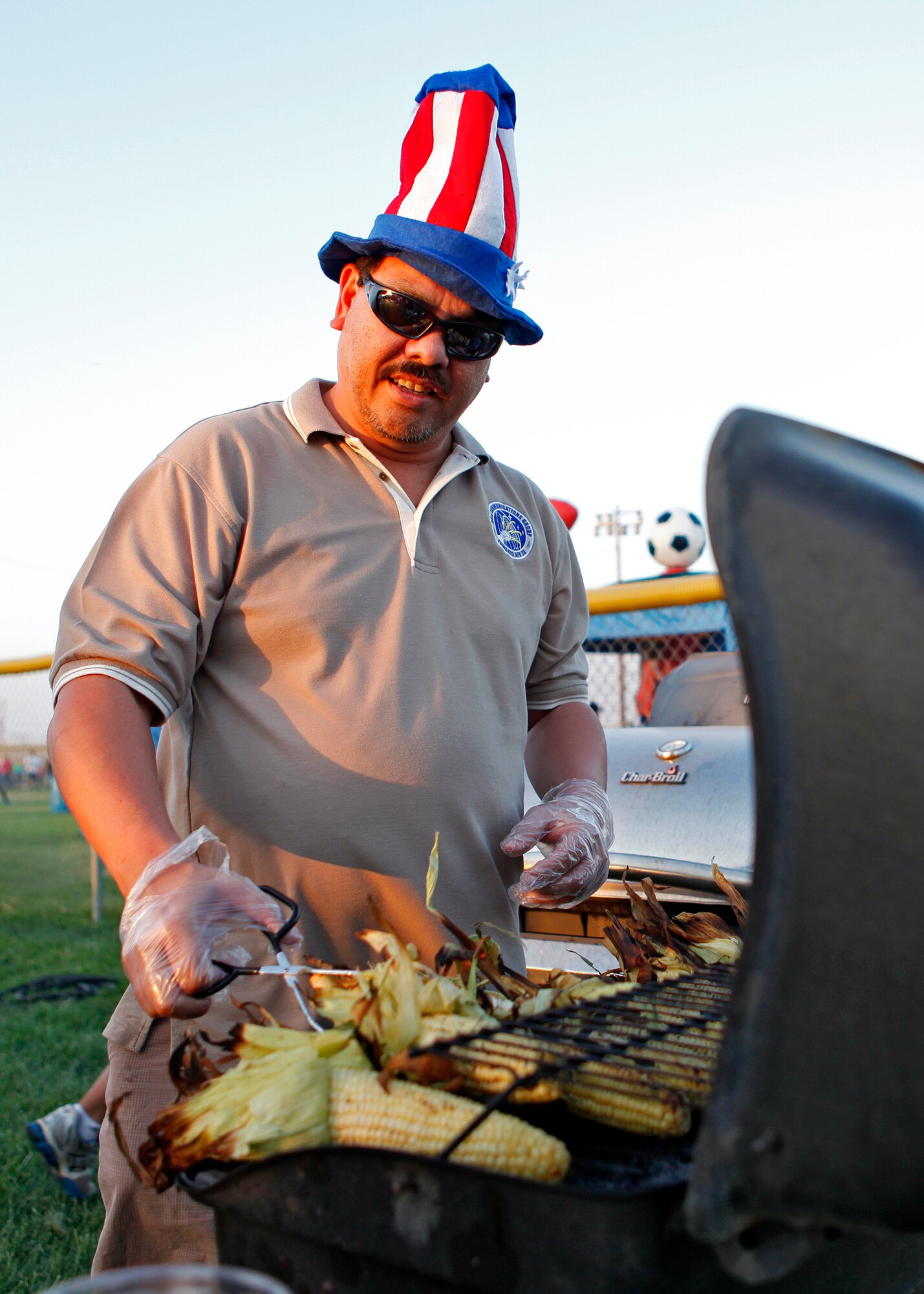 A volunteer prepares corn to be sold during the 2012 Summer Bash at Edwards Air Force Base, Calif. on July 4. (U.S. Air Force photo by Jet Fabara)