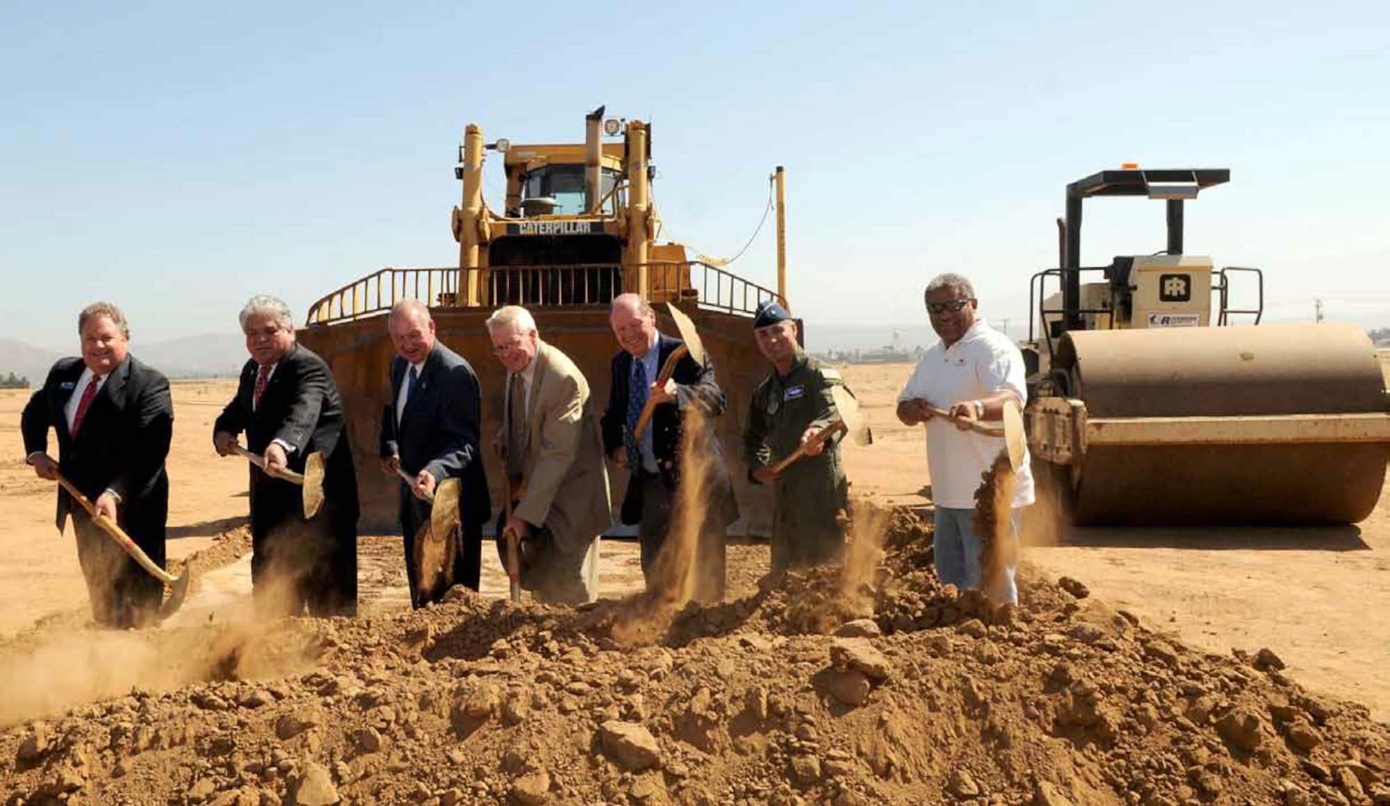 From Left: Assemblyman Jeff Miller, 71st District; Under Secretary for Memorial Affairs Steve Muro, Department of Veterans Affairs; Riverside City Councilman Mike Garner, Ward 1; Riverside County Supervisor Bob Buster, 1st District; Riverside County  Supervisor Marion Ashley, 5th District; Brig. Gen. Karl McGregor, 452d Air Mobility Wing commander; and Moreno Valley City Councilmember Bill Batey, 5th District, break ground for the new Van Buren/Highway 215 overpass on June 8. The new  overpass is dedicated to the history of March Field and when completed, will depict the various aircraft and commands which were stationed here. The new design also will make it easier to enter and exit the freeway. (Photo courtesy to U.S. Air Force)
