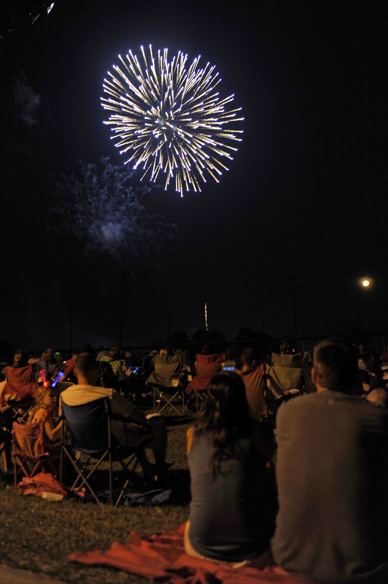 Members of Team Seymour watch as fireworks explode overhead during an Independence Day Celebration at Seymour Johnson Air Force Base, N.C., July 3, 2012. The fireworks lit up the sky to conclude the evening’s event. (U.S. Air Force photo/Airman 1st Class John Nieves Camacho/Released)