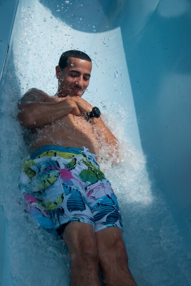U.S. Air Force Airman 1st Class Willis Polanco, 723d Aircraft Maintenance Squadron crew chief, goes down a water slide during an Independence Day celebration at Moody Air Force Base, Ga., July 4, 2012.  The 23d Force Support Squadron hosted the event for Team Moody families to celebrate the independence of the United States. (U.S. Air Force photo by Airman 1st Class Paul Francis/Released) 