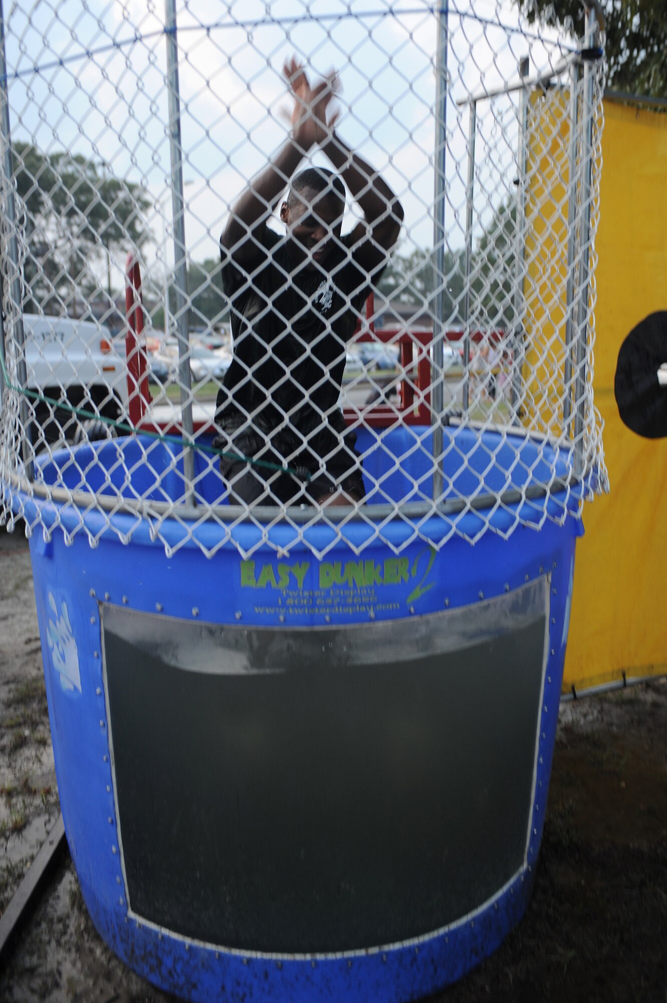 U.S. Air Force Master Sgt. Brandon Suber begins his decent into a dunk tank during an Independence Day Celebration at Seymour Johnson Air Force Base, N.C., July 3, 2012. Patrons had the opportunity to dunk first sergeants as part of the celebration. Suber, 4th Comptroller Squadron first sergeant, is from Cleveland. (U.S. Air Force photo/Airman 1st Class John Nieves Camacho/Released)