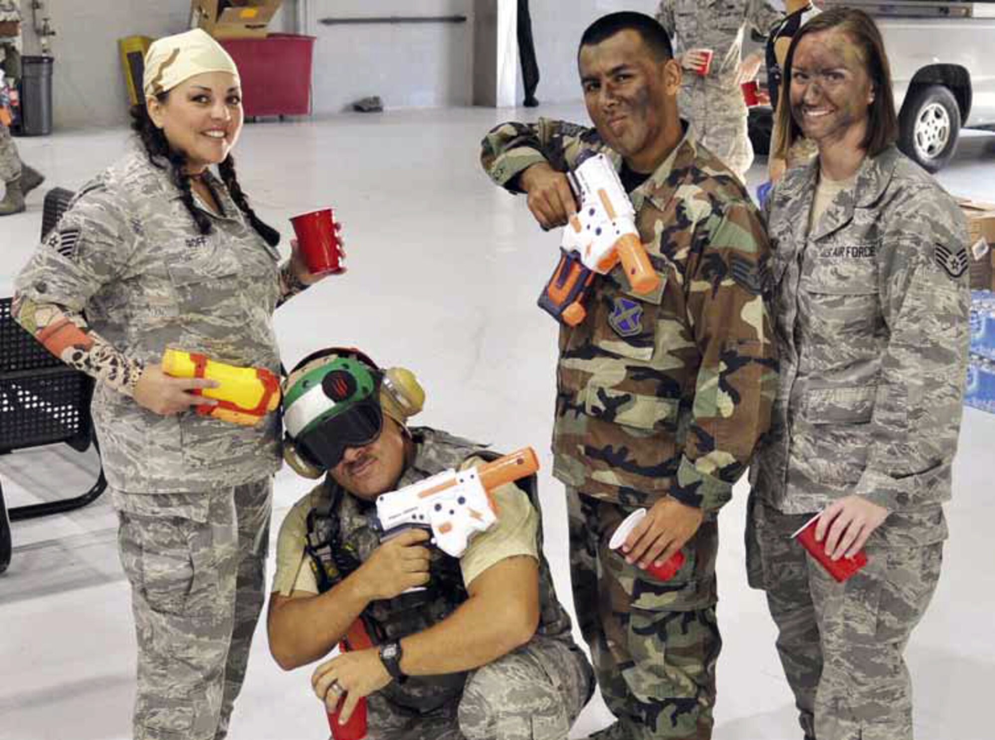 Tech. Sgt. Crystal Goff, Senior Master Sgt. Eric Butt, Staff Sgt. Daniel Garcia and Staff Sgt. Sara Luna, all members of the 912 ARS, are prepped and ready for the start of the 912th ARS’s Combat Dining-In, held in Hangar 2306, June 15. Luna, Butt, and Goff were all members of the planning committee that organized the festivities. (U.S. Air Force photo by Megan Crusher)