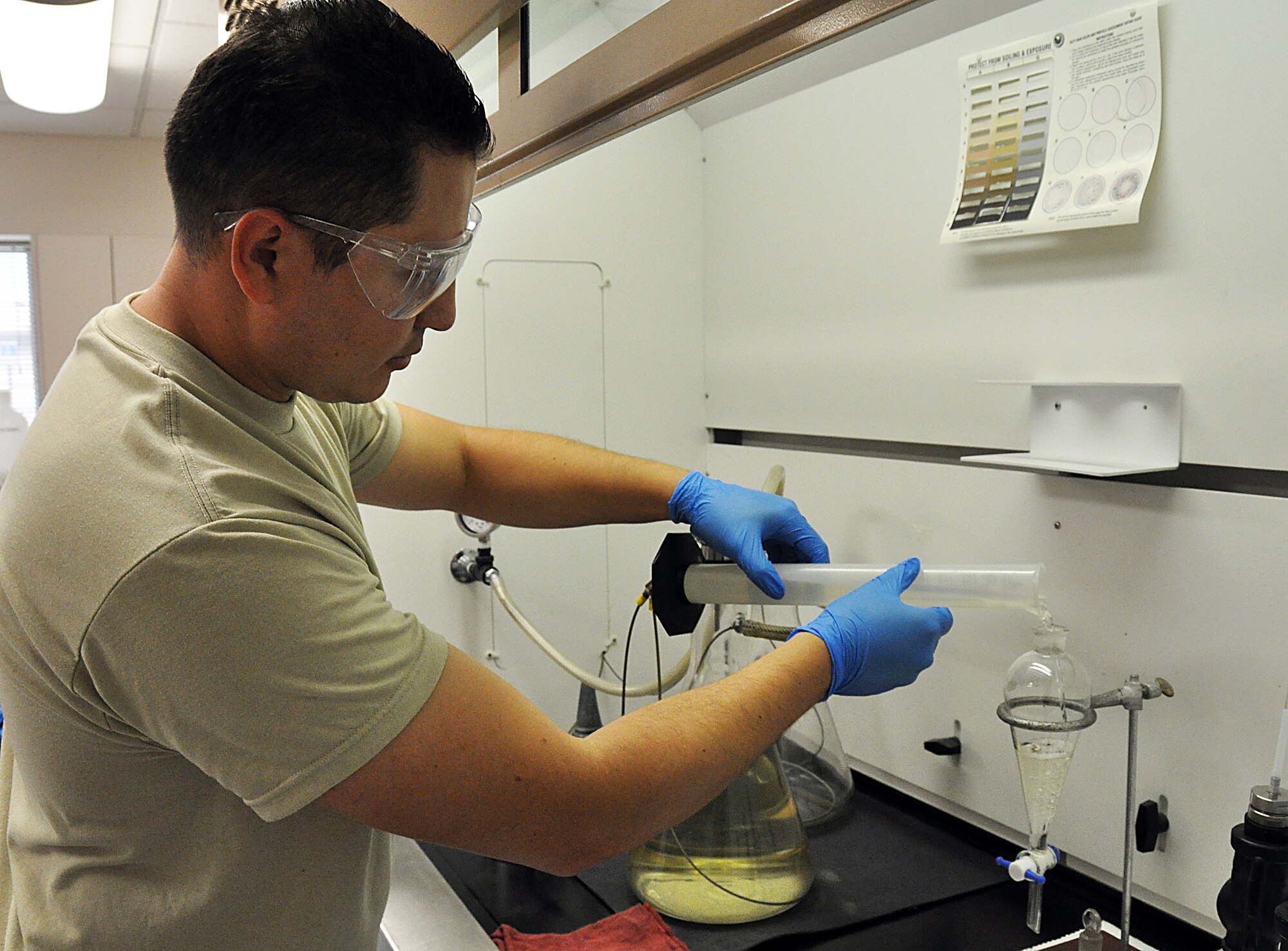 TSgt. Heber Moreno Moyo, Fuels Journeyman from the  482nd Fuels Management Flight, pours fuel into a beaker to test for dirt or foreign substances. The flight tests all fuel delivered to the base regularly. Fuel is tested for dirt, water and consistency to ensure it's safe to use.(U.S. Air Force photo/Senior Airman Jacob Jimenez)