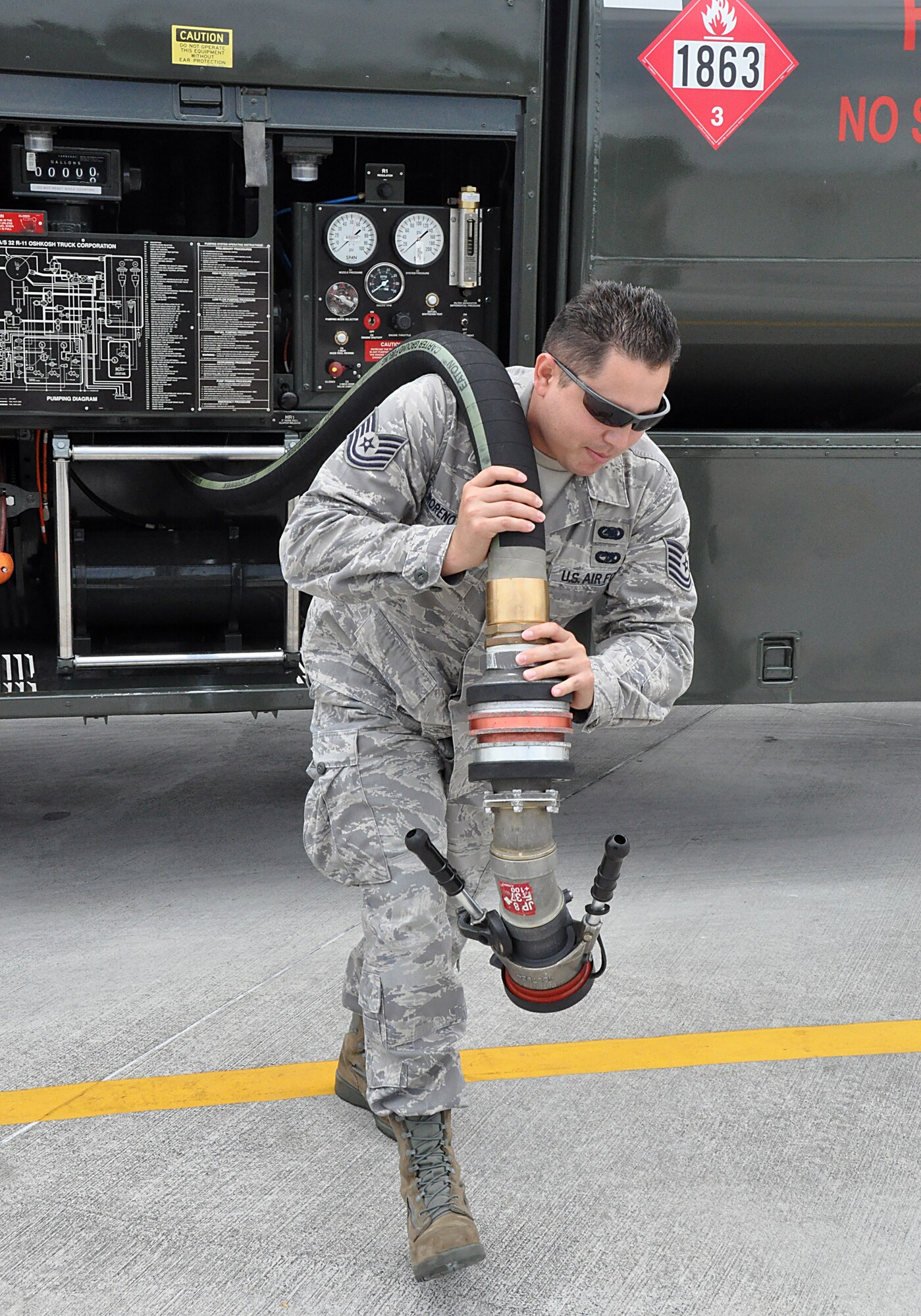 TSgt. Heber Moreno Moyo, Fuels Journeyman from the  482nd Fuels Management Flight, unravels a fuel truck refueling hose as part of the process of refueling. In 2011 the 482nd Fuels Management Flight pumped 6,000,000 gallons of fuel and fueled 5,000 aircraft. The flight fuels all aircraft at Homestead Air Reserve Base and all base government vehicles. (U.S. Air Force photo/Senior Airman Jacob Jimenez)