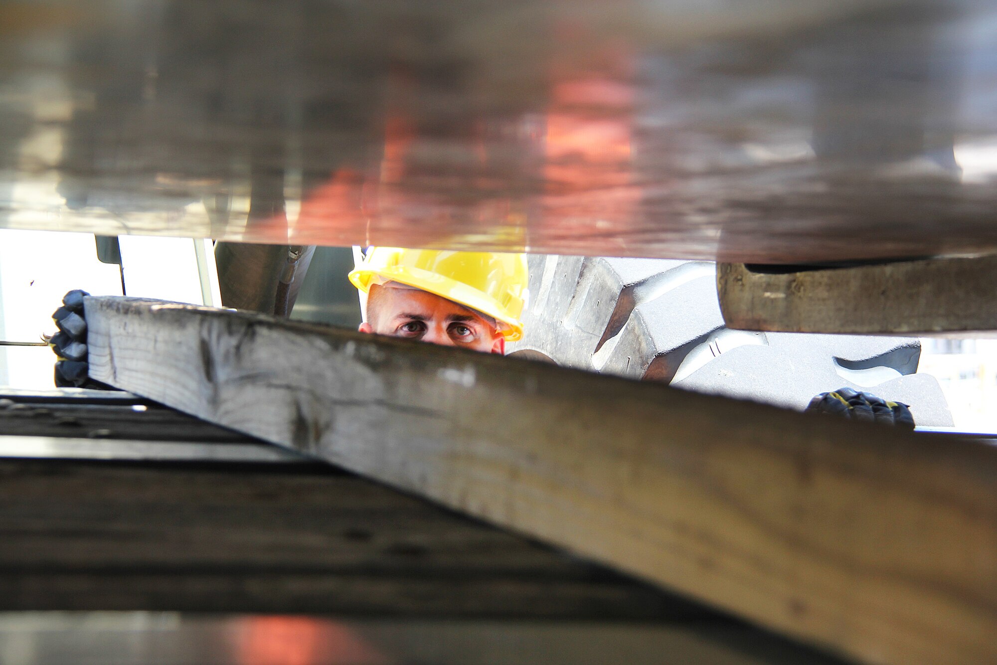 An Airman places dunnage between a pallet and a truck bed.( U. S. Air Force photo/ Robert Talenti)