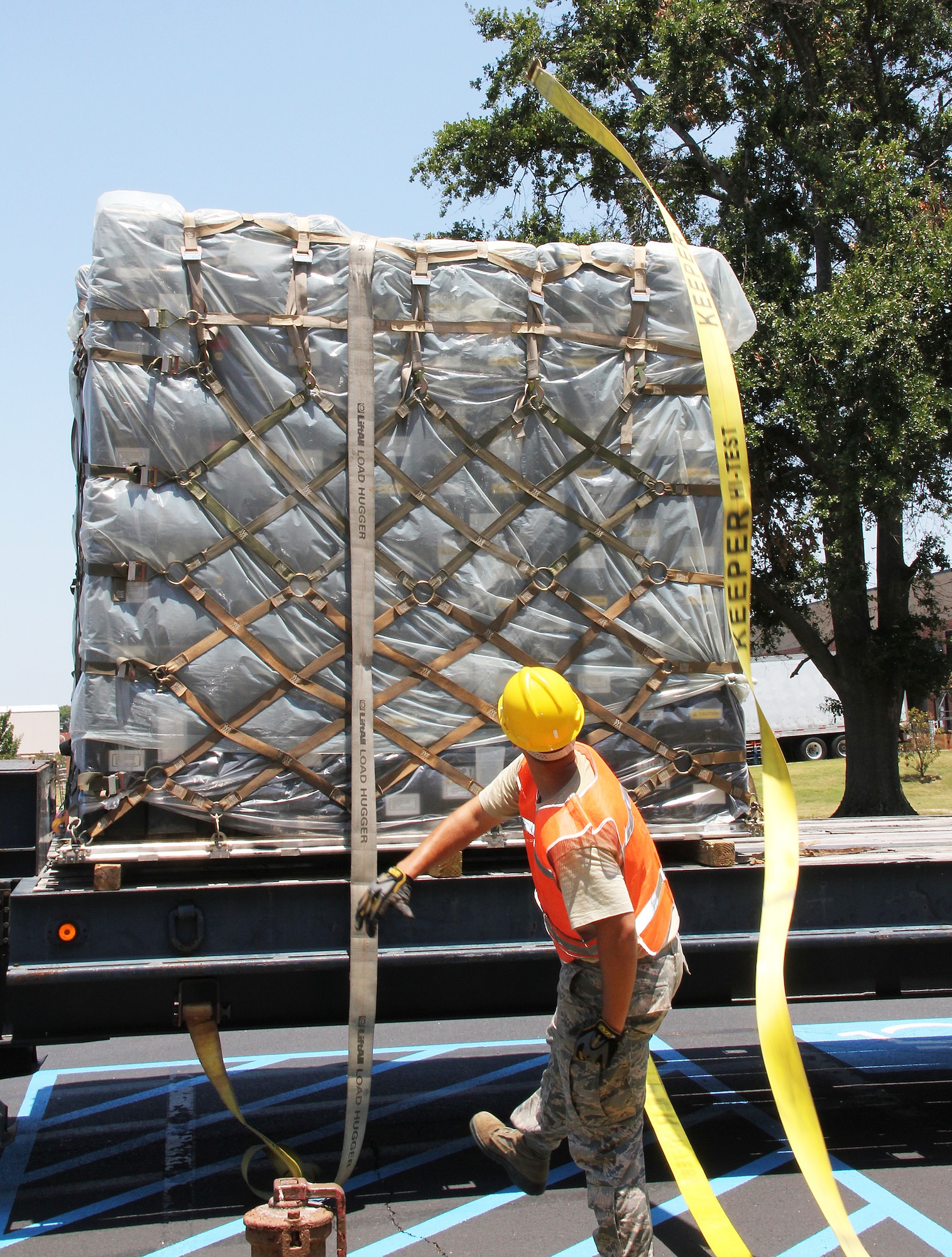 Senior Airman William Wilson, 51st Combat Communications Squadron power production technician, throws a strap over a pallet June 28. The 51st CCS is on-call to support firefighting operations in Colorado with nearly 123,000 pounds of communications equipment.)U. S. Air Force photo/ Robert Talenti) 