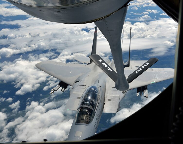 The 157th Air Refueling Wing, Pease NH, prepares to refuel an F-15 from the 104th Fighter Wing, Westfield MA, high above northern New England on June 29, 2012. In Prone position, boom operator TSgt. Justin Poteet of the 157th will transfer fuel that will allow the F-15s to continue their "dog fight" training exercises. (U.S. Air Force photo/SrA. Kelly Galloway)