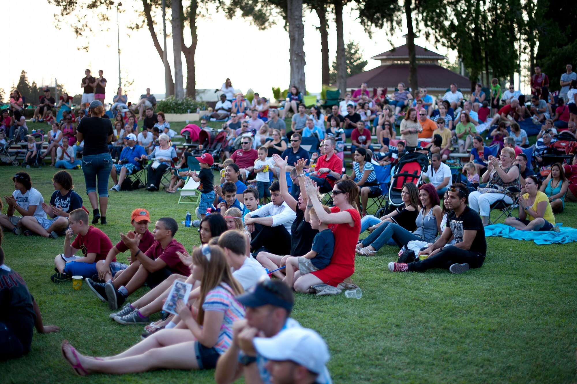 Members of Team Incirlik applaud during a performance at  Independence Day celebrations July 4, 2012, at Arkadas Park, Incirlik Air Base, Turkey. The event included a performance from six members of the American Idol Tour. (U.S. Air Force photo by Senior Airman William A. O'Brien/Released)