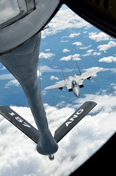 The 157th Air Refueling Wing, Pease NH, prepares to refuel an F-15 from the 104th Fighter Wing, Westfield MA, high above northern New England on June 29, 2012. In Prone position, boom operator TSgt. Justin Poteet of the 157th will transfer fuel that will allow the F-15s to continue their "dog fight" training exercises. (U.S. Air Force photo/SrA. Kelly Galloway)