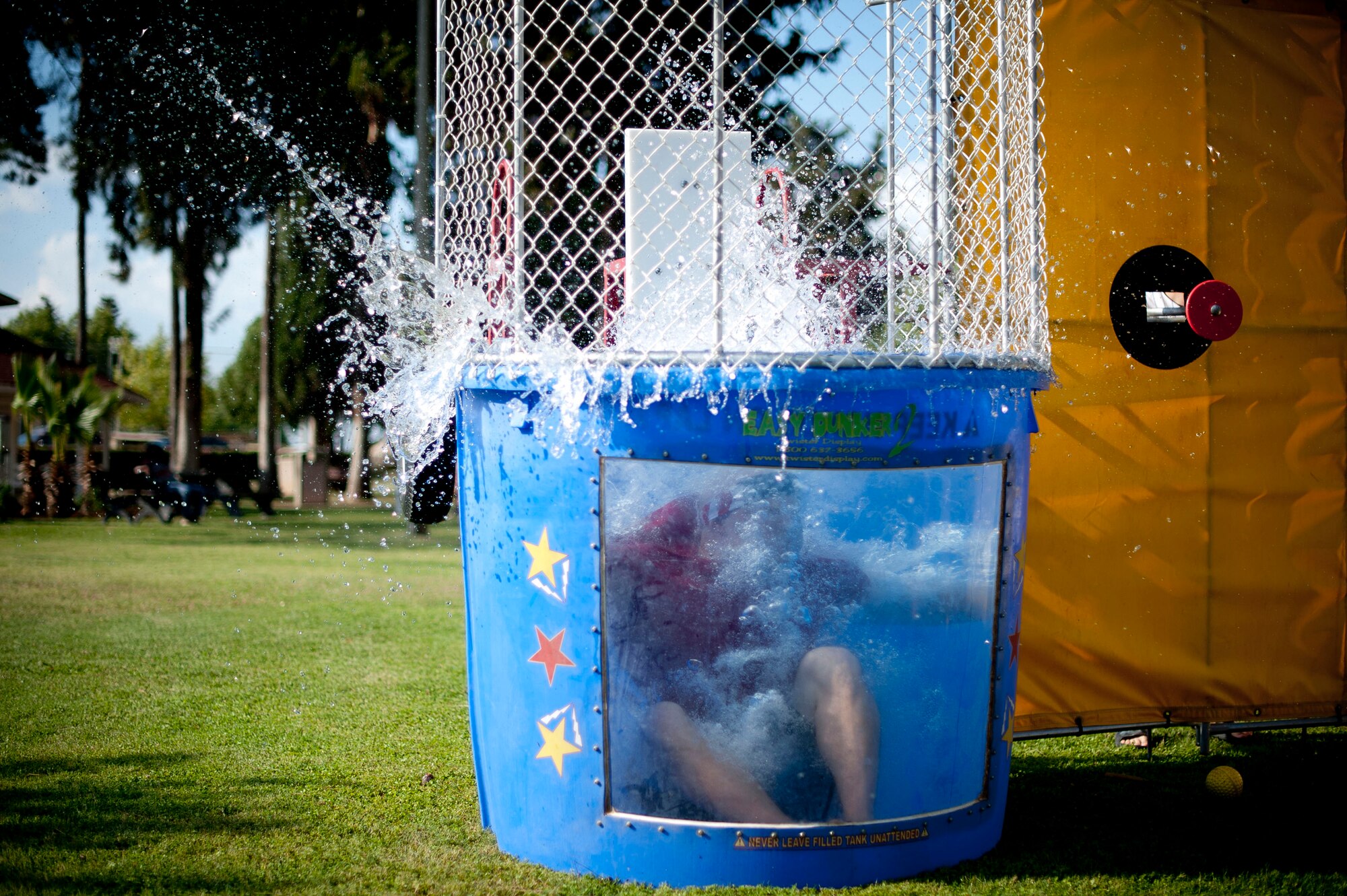 A volunteer splashes into the dunk tank during Independence Day celebrations July 4, 2012, at Arkadas Park, Incirlik Air Base, Turkey. The activities included competitions, food and live entertainment. (U.S. Air Force photo by Senior Airman William A. O'Brien/released)