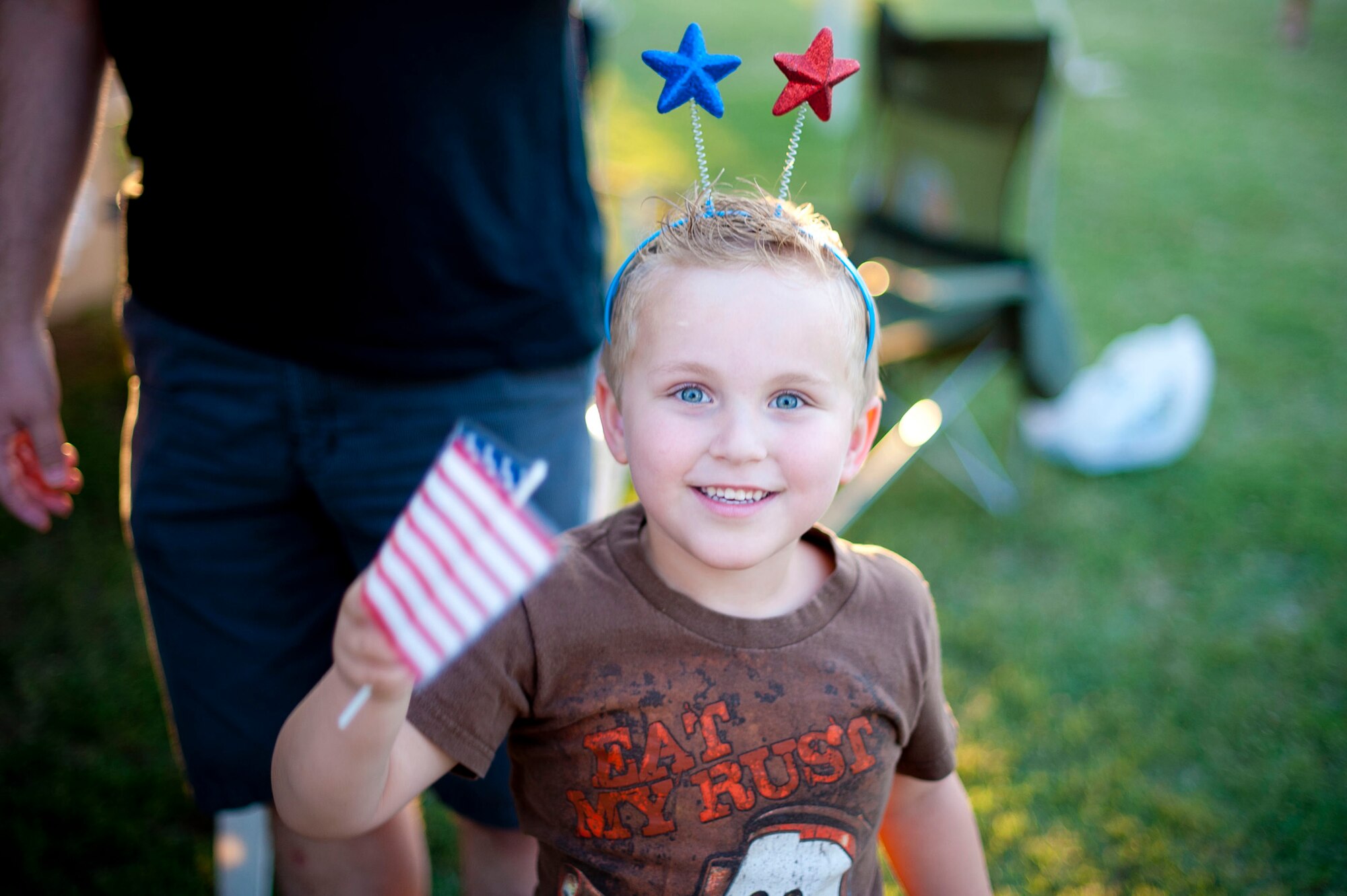 A child waves a flag during an Independence Day celebration July 4, 2012, at Arkadas Park on Incirlik Air Base, Turkey. Activities included competitions, food and live entertainment. (U.S. Air Force photo by Senior Airman William A. O'Brien/Released)