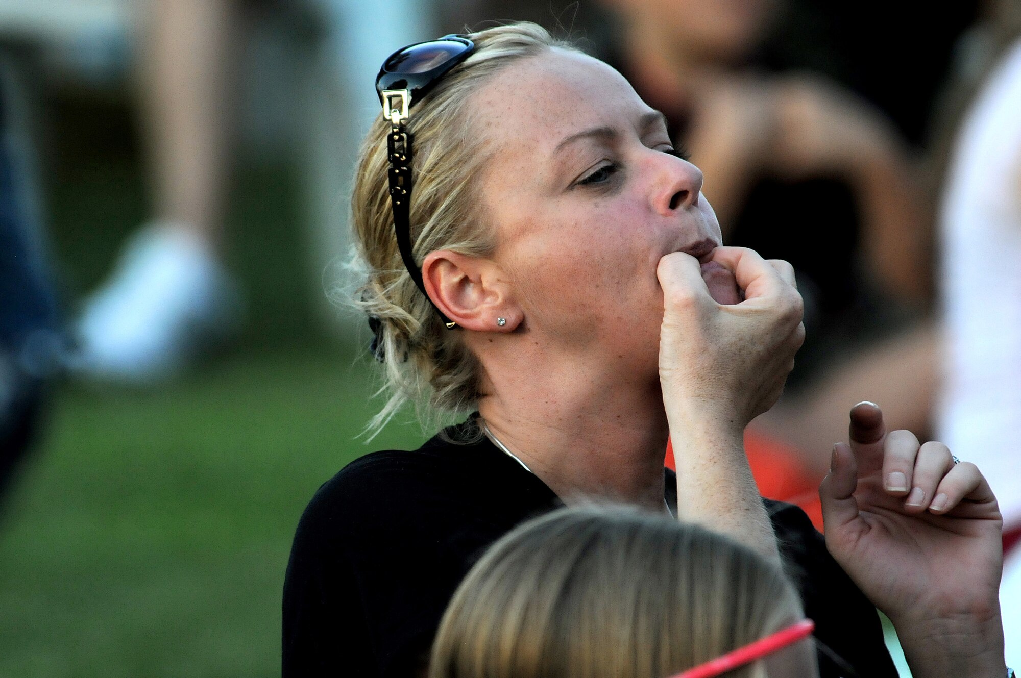Tech. Sgt. Jennifer Rowles, 39th Operations Squadron, whistles for a performer during the opening acts for the American Idol Tour concert July 4, 2012, at Incirlik Air Base, Turkey. The Independence  Day events at Incirlik included a Strongman Competition, a concert from the Idols Tour and a firework display. (U.S. Air Force photo  by Senior Airman Marissa Tucker/Released)
