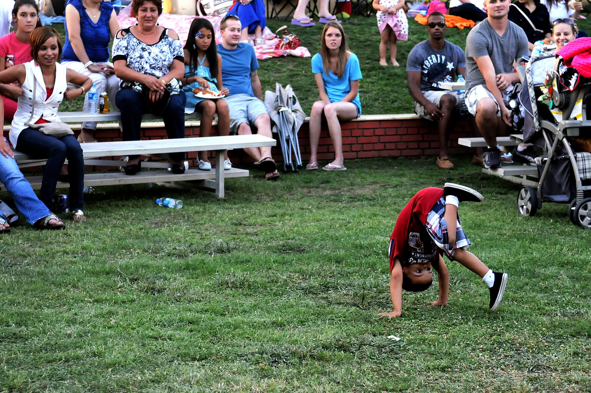 A child somersaults during the Independence Day celebration July 4, 2012, at Incirlik Air Base, Turkey. The Independence  Day events at Incirlik included a Strongman Competition, a concert from the American Idol Tour and a firework display. (U.S. Air Force photo  by Senior Airman Marissa Tucker/Released)