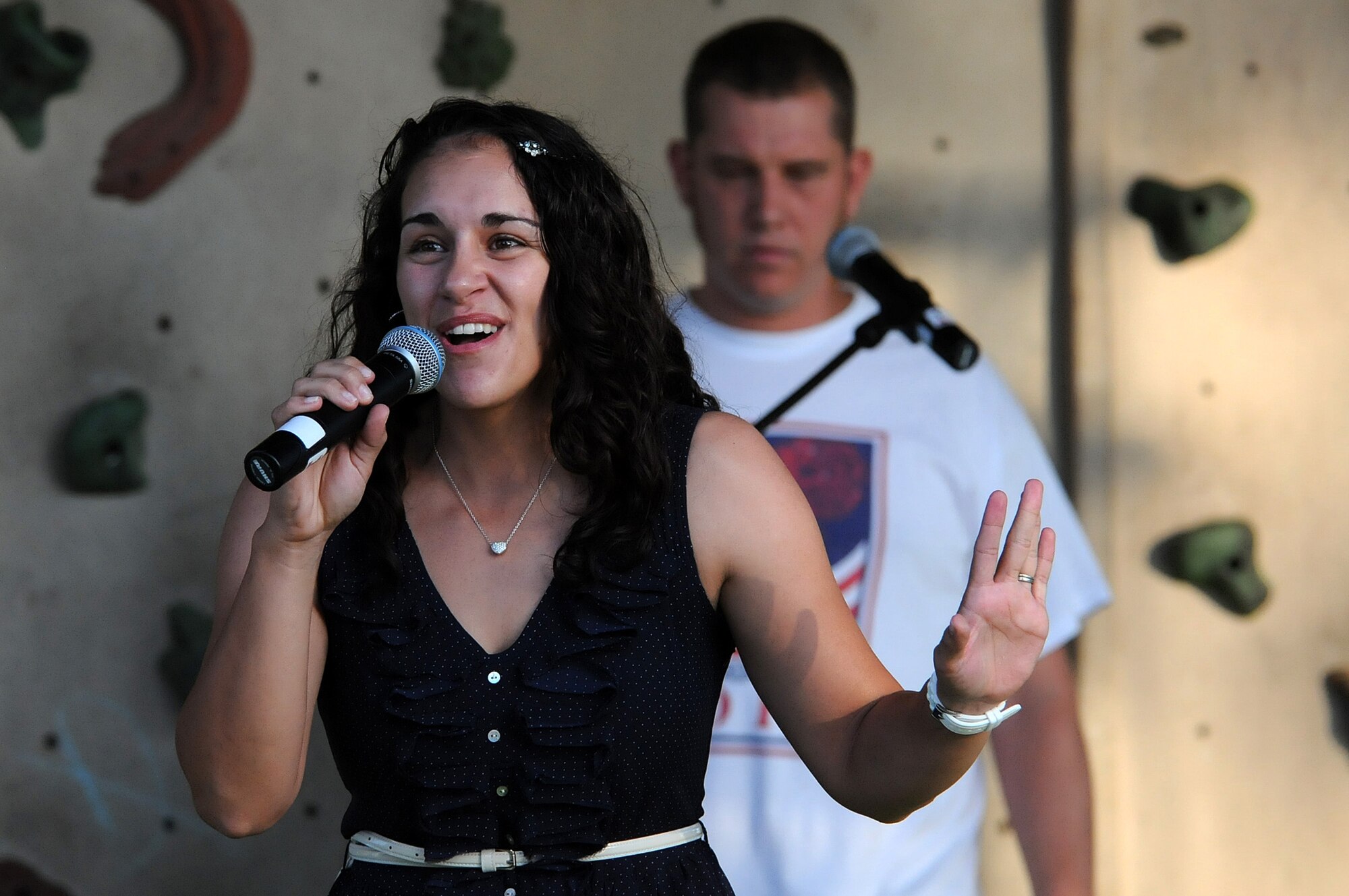 Capt. Gina McKeen, 39th Air Base Wing public affairs officer, sings "River Deep" during the Independence Day celebration July 4, 2012, at Incirlik Air Base, Turkey. McKeen performed with other winners from the Incirlik Idol and The U Got Talent competitions as opening acts  for the American Idol Tour during the celebration. (U.S. Air Force photo by Senior Airman Marissa Tucker/Released)